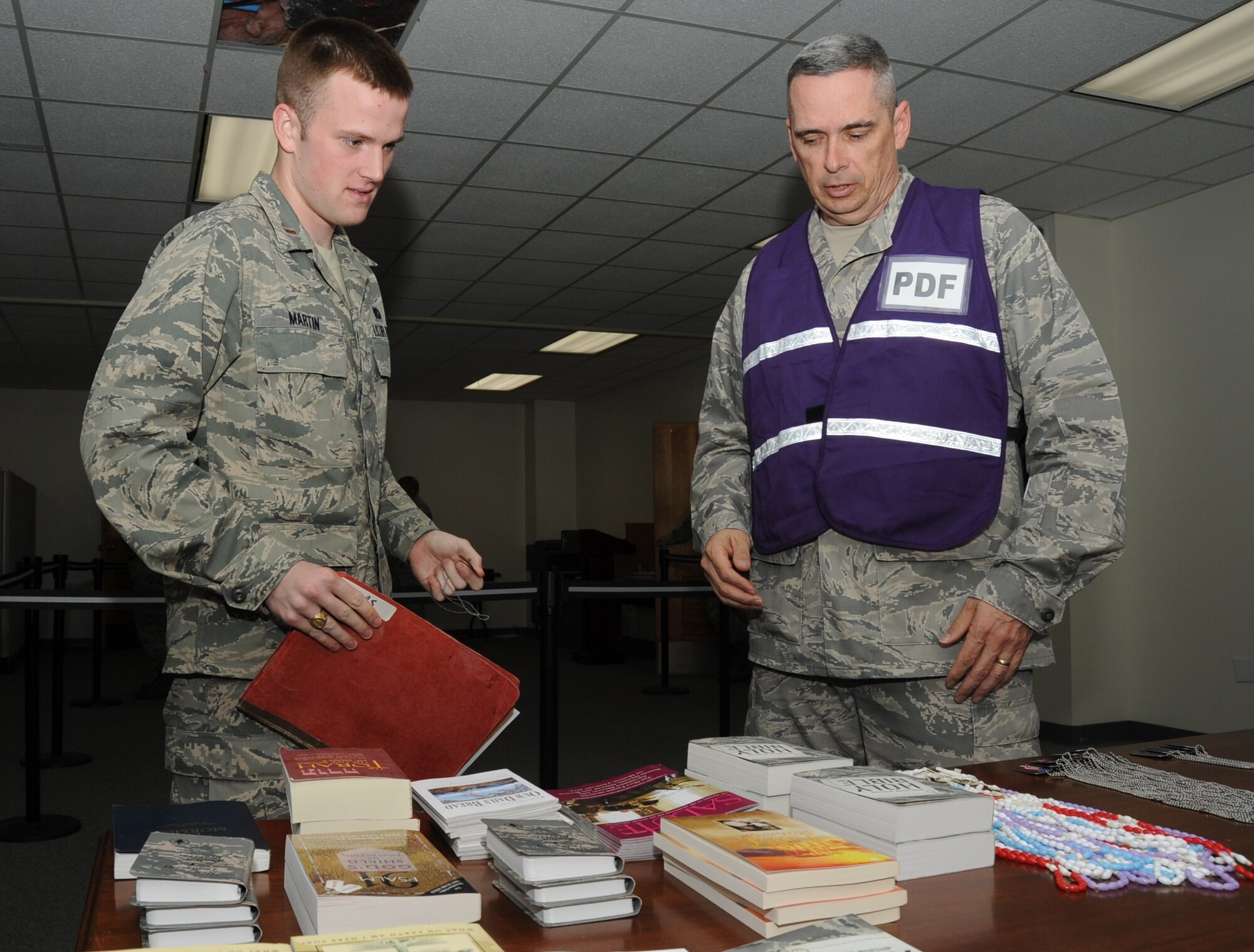 Second Lt. David Martin, 81st Logistics Readiness Squadron, reviews the literature that Chaplain (Maj.) Mark Thomas, 81st Training Wing, may have to offer him while he is “deployed,” during a deployment exercise March 29, 2012, outside the 81st Logistics Readiness Squadron warehouse at Keesler Air Force Base, Miss.  (U.S. Air Force photo by Kemberly Groue)