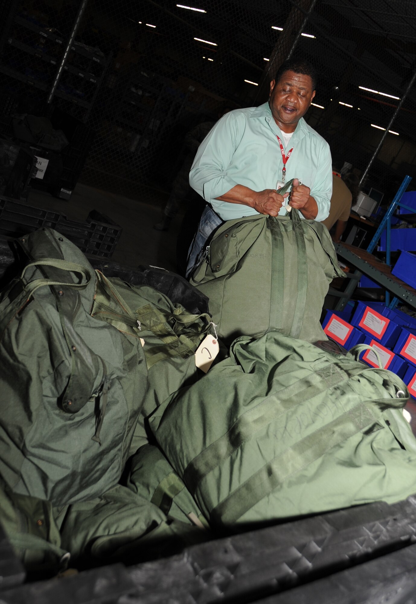 Ed Lee, CSC,  palletizes A and C mobility bags during a deployment exercise March 29, 2012, inside the 81st Logistics Readiness Squadron warehouse at Keesler Air Force Base, Miss.  After the “deployed” troops have issued their mobility bags they are passed on to Lee.  (U.S. Air Force photo by Kemberly Groue)