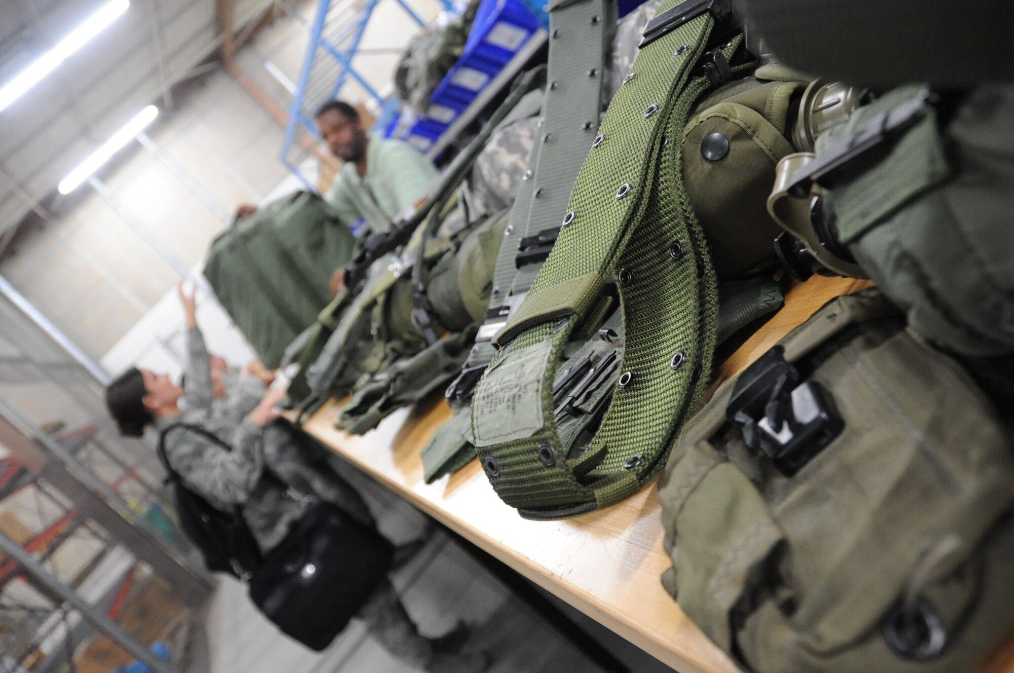 Senior Airman Patsy Chandler, 81st Logistics Readiness Squadron, receives a mobility bag issued by Earl Ellis, CSC, during a deployment exercise March 29, 2012, inside the 81st Logistics Readiness Squadron warehouse at Keesler Air Force Base, Miss.  (U.S. Air Force photo by Kemberly Groue)