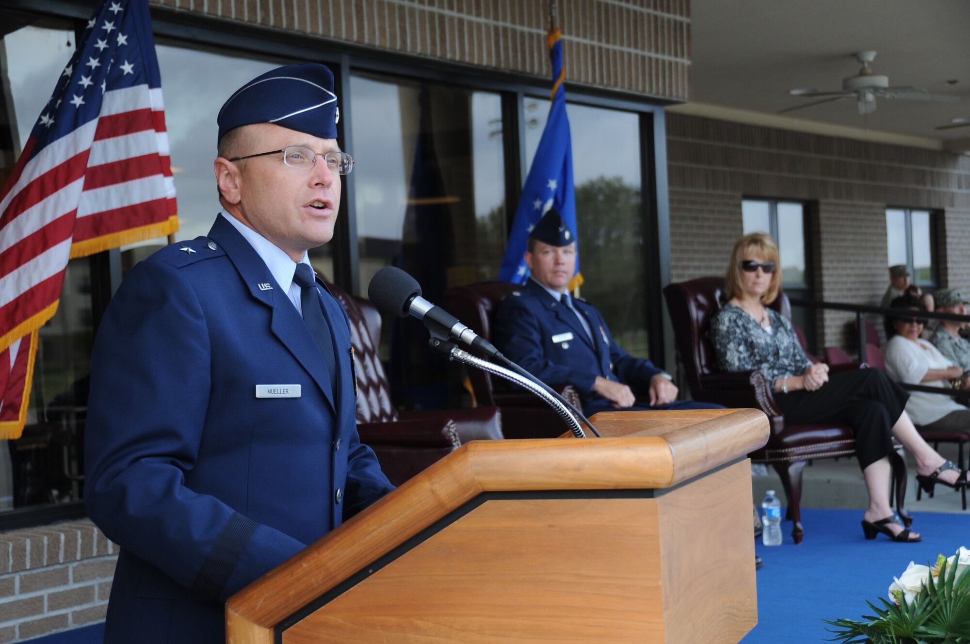 Brig. Gen. Andrew Mueller, 81st Training Wing commander, delivers remarks to the audience as Devalyn and Lt. Col. Scott Solomon, 81st Training Group deputy commander,  listen during a student parade March 19, 2012, in the triangle area at Keesler Air Force Base, Miss.  Solomon officiated over the parade before making his permanent change of station.  (U.S. Air Force photo by Kemberly Groue)