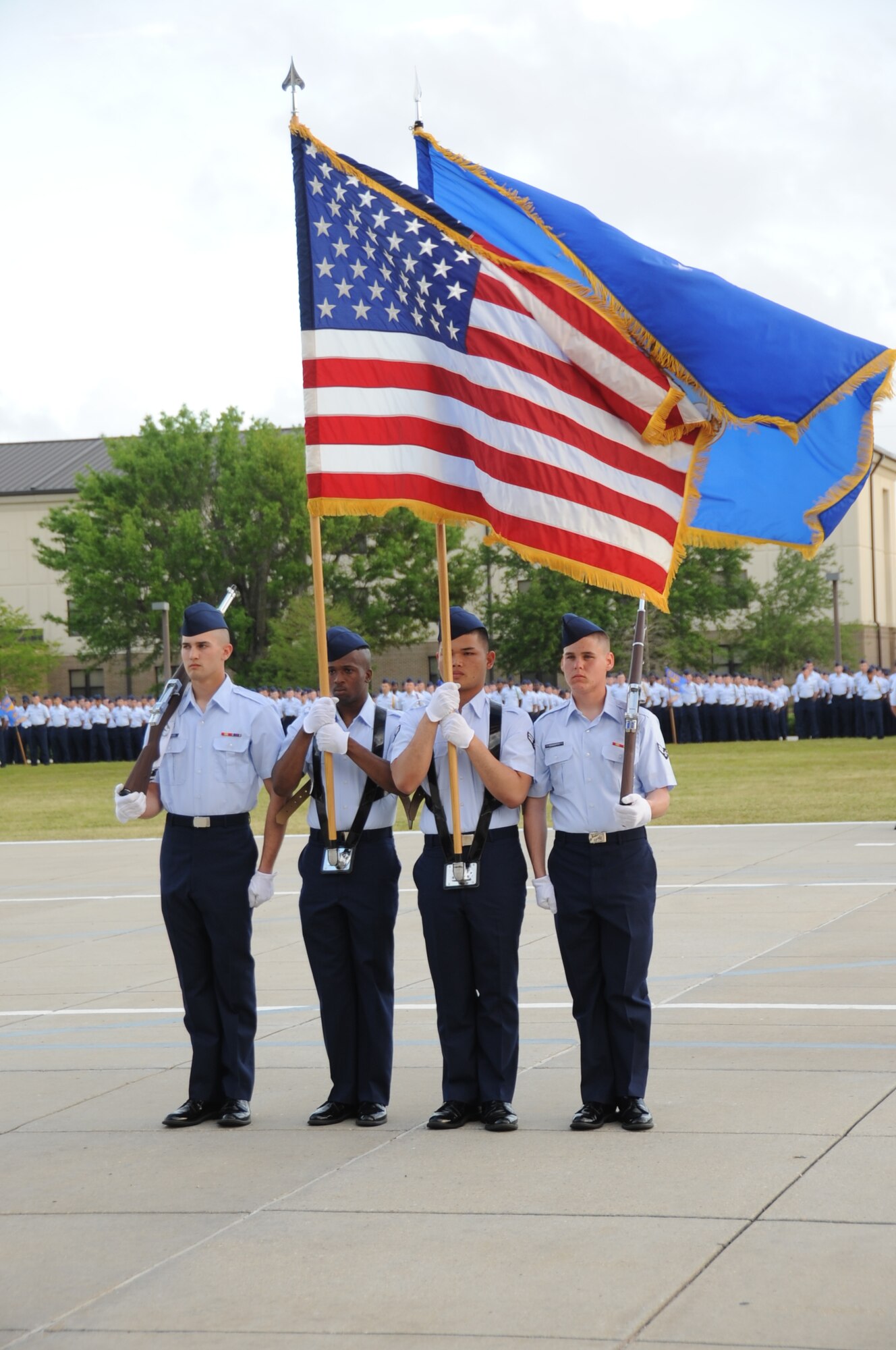 The flag detail marches forward for the singing of the National Anthem during a student parade March 19, 2012, in the triangle area at Keesler Air Force Base, Miss.  (U.S. Air Force photo by Kemberly Groue)