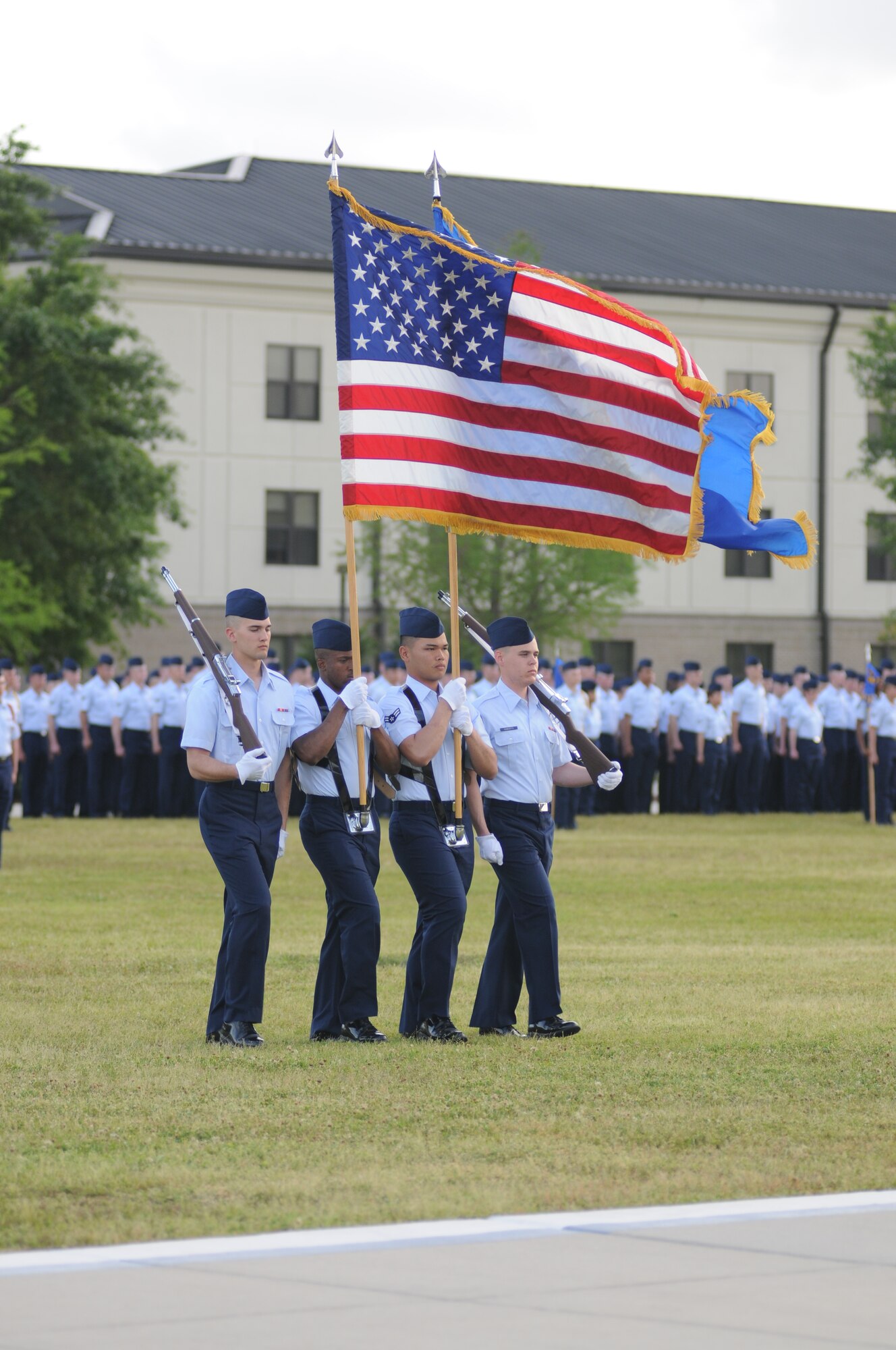 The flag detail marches forward for the singing of the National Anthem during a student parade March 19, 2012, in the triangle area at Keesler Air Force Base, Miss.  (U.S. Air Force photo by Kemberly Groue)
