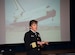 Navy Capt. Heidemarie M. Stefanyshyn-Piper, Carderock Division, Naval Surface Warfare Center commander, addresses a Joint Base Andrews audience during an Andrews Leadership Series event at the Community Activity Center on Mar. 29.  In the background is a slide of the space shuttle Endeavor, taken while Stefanyshyn-Piper served as an astronaut during the shuttle’s 2008 space mission.  (Photo/Bobby Jones)