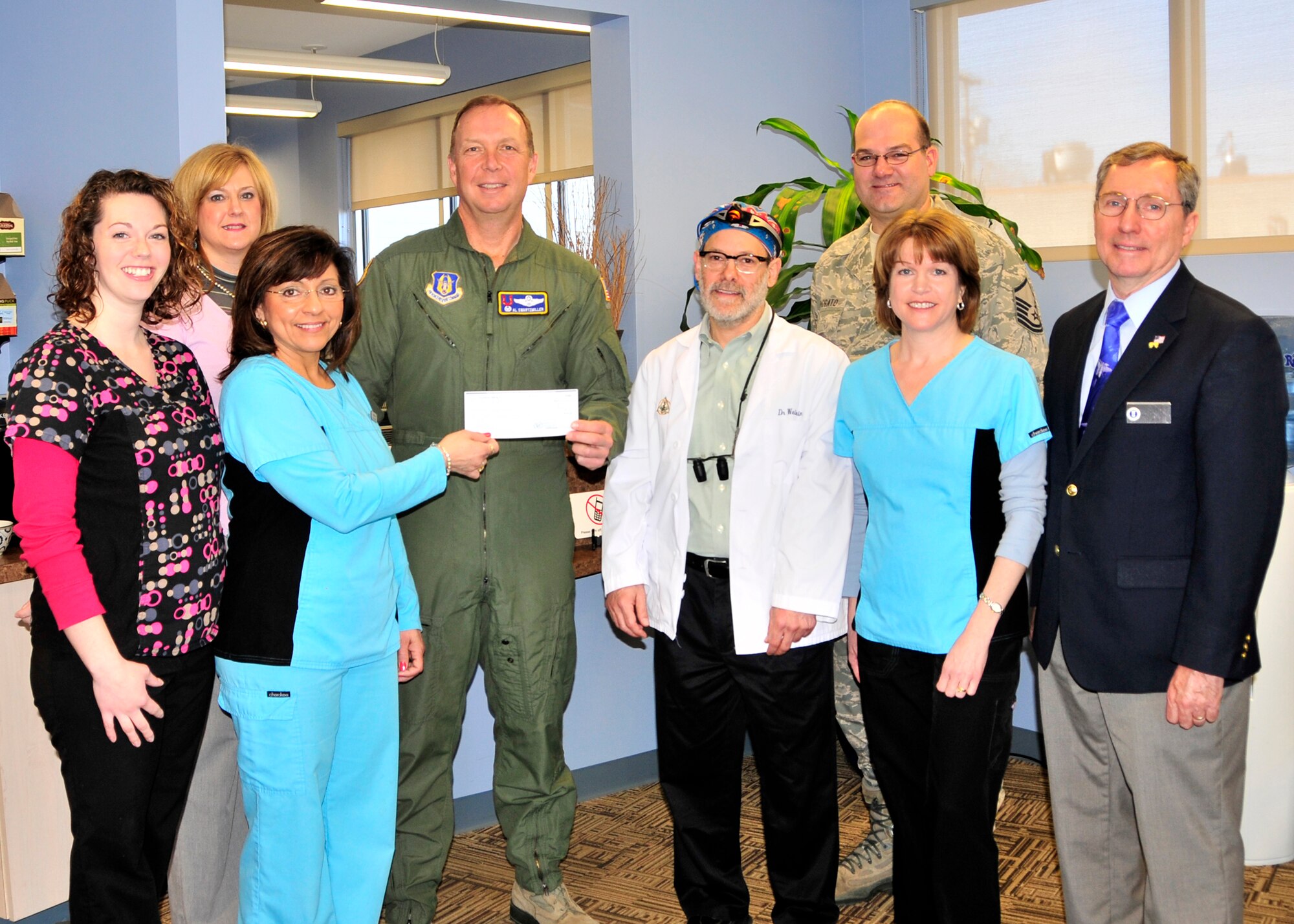 Mary Grace, Advanced Dental Center hands 914th Airlift Wing Commander Allan Swartzmiller a donation from the Advanced Dental Center to the Niagara Falls Air Reserve Stations Family Support Programs, March 3, 2012 Niagara Falls, NY. In attendance was Laura Hood Advanced Dental Center, Jeanne Goetze, 107th Airlift Wing Family Readiness, Dr. Stuart Weinstein,  Advanced Dental Center, 914 AW Master Sgt. Marty Viggato, Carla Siwinski, Advanced Dental Center, and Mr. Jim Germain, Director of Airman and Family Readiness at the Niagara Falls Air Reserve Station. (U.S. Air Force photo by Tech Sgt. Joseph McKee)