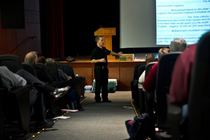 Joseph Butta gives a speech to Airmen and civilians at the Joint Base Charleston - Air Base Theater April 3 as a part of teh Air Mobility Command Arms Control Treaty Workshop. Butta specializes in issues related to the Middle East including the three monotheistic religions which originated in the region. (U.S. Air Force photo by Airman 1st Class George Goslin)