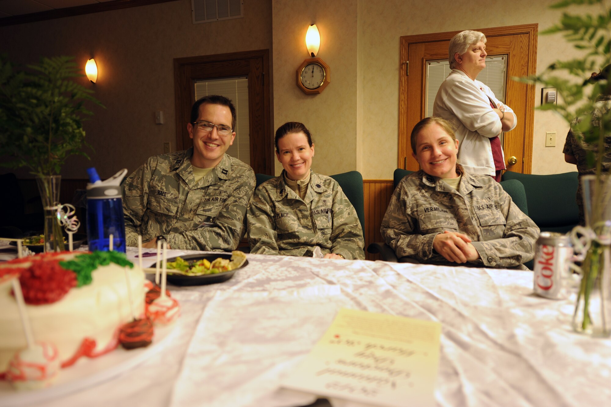 From left: Capt. Matthew Hall, Lt. Col. Laura Place and Capt. Kendall Vermillion, sit at the table of honor during a National Doctor’s Day commemoration ceremony on March 30, 2012, at the 319th Medical Group on Grand Forks Air Force Base, N.D. (U.S. Air Force photo/Tim Flack)