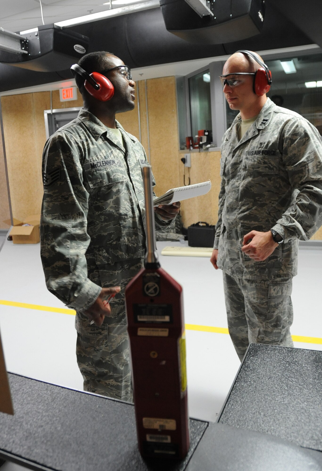 Staff Sgt. Sterling McClennon and Capt. Chris Judy, 81st Aerospace Medicine Squadron bioenvironmental, discuss the level of noise registered during an indoor firing range safety test March 28, 2012, at Keesler Air Force Base, Miss.  (U.S. Air Force photo by Kemberly Groue)