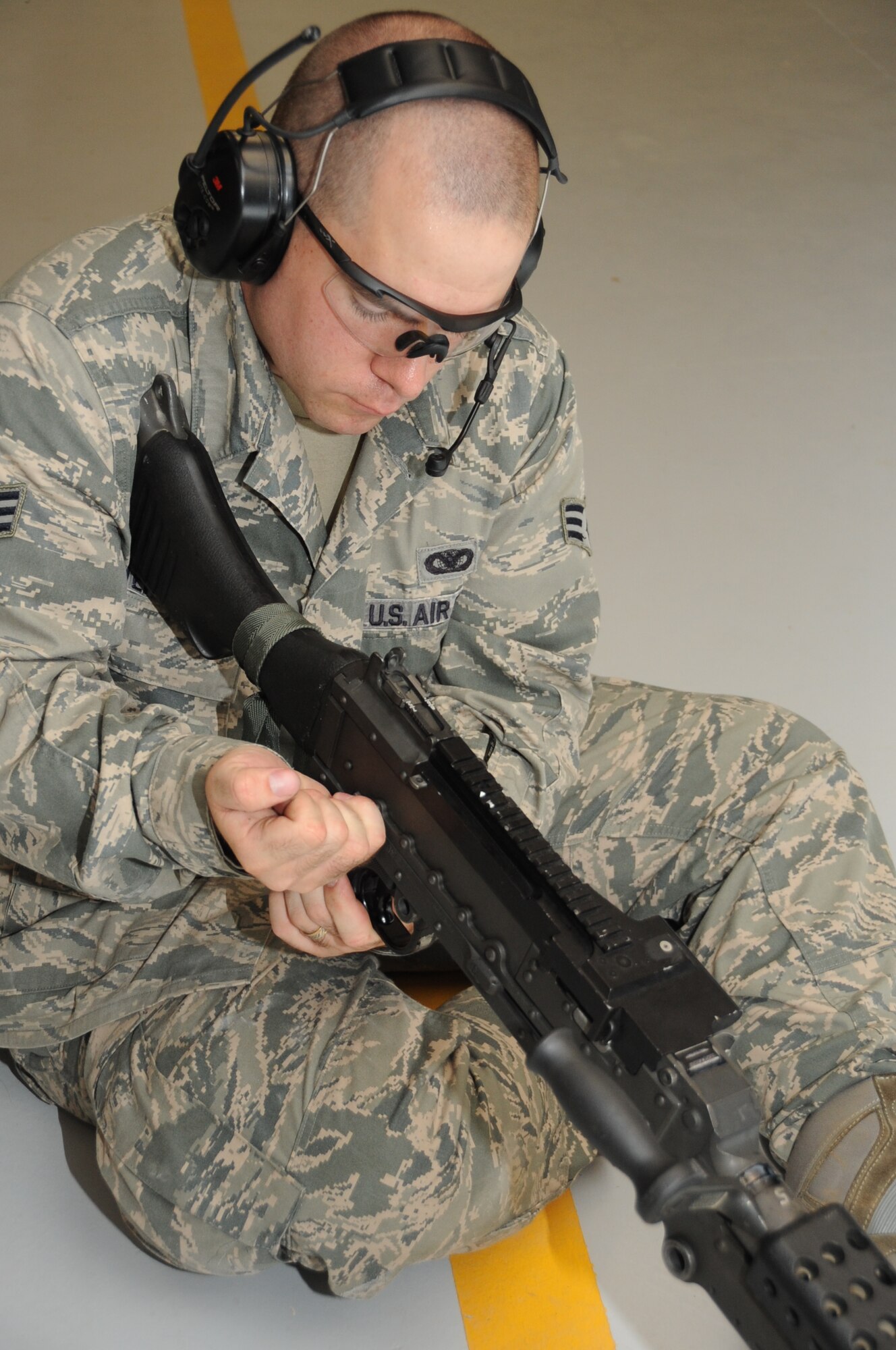 Senior Airman Jesse Peterson, 81st Security Forces Squadron combat arms, rebuilds an M240B during an indoor firing range safety test March 28, 2012, at Keesler Air Force Base, Miss.  The safety tests were conducted to ensure that rounds would not ricochet back toward members firing their weapons.  (U.S. Air Force photo by Kemberly Groue)