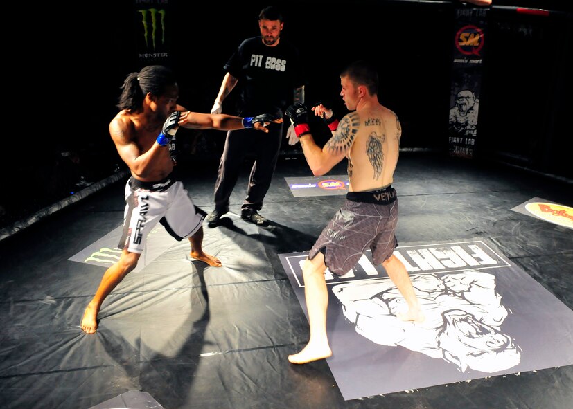 Two mixed martial arts fighters begin getting the feel for each other’s technique as their match begins at Shaw's fitness center, Shaw Air Force Base, S.C., March 30, 2012. More than 900 Team Shaw members attended the competition, making it the largest paid event to occur on the installation. (U.S. Air Force photo by Senior 