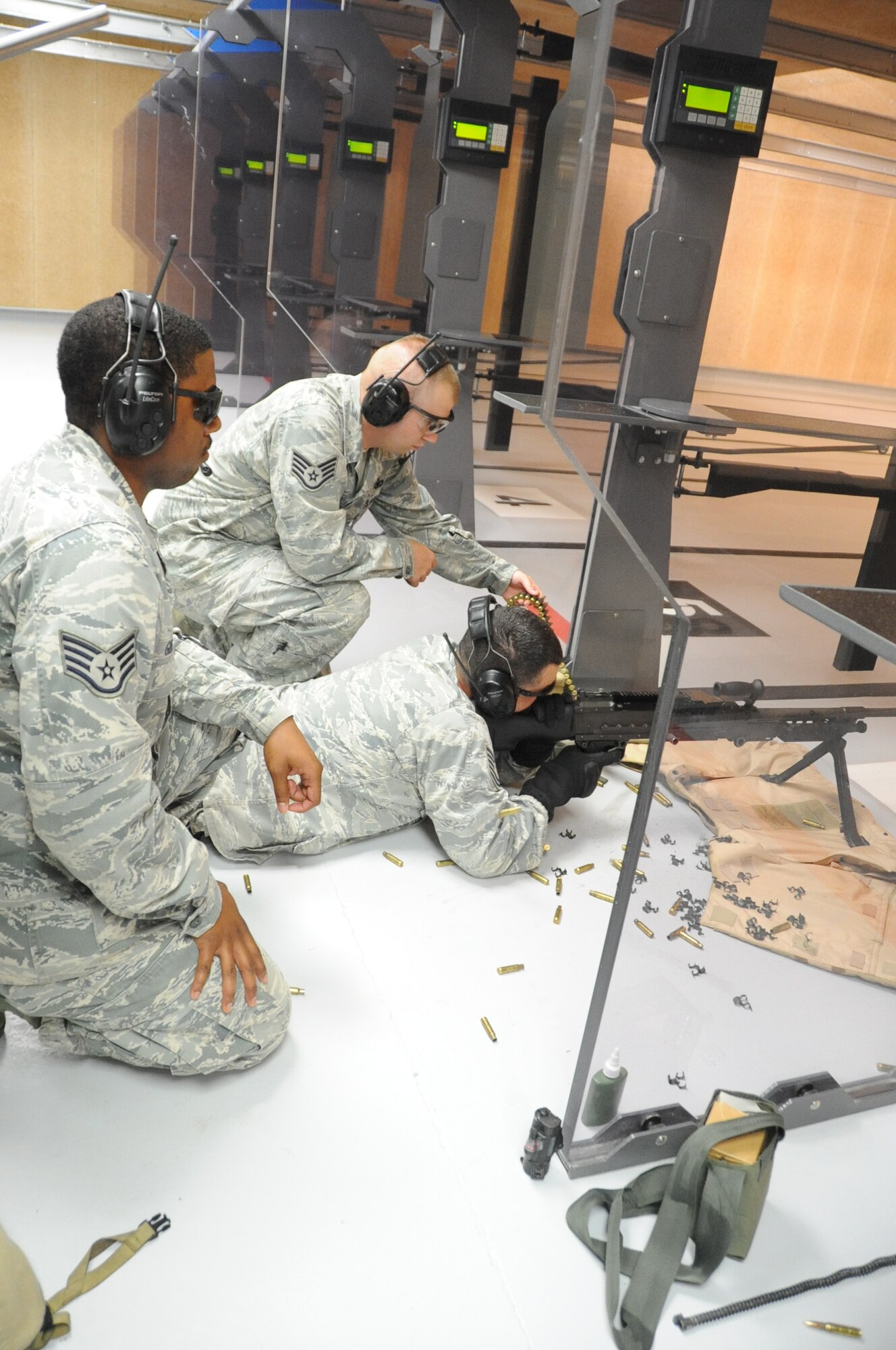 Tech. Sgt. Barry Hardy, 81st Security Forces Squadron combat arms fires an M240B from the prone position into the metal backstop as other 81st SFS members Staff Sgt. Michael O’Neil and Staff Sgt. Richard Gibbs stand by during an indoor firing range safety test March 28, 2012, at Keesler Air Force Base, Miss.  The ricochet containment test was conducted to ensure the metal backstop would catch each round fired.  (U.S. Air Force photo by Kemberly Groue)