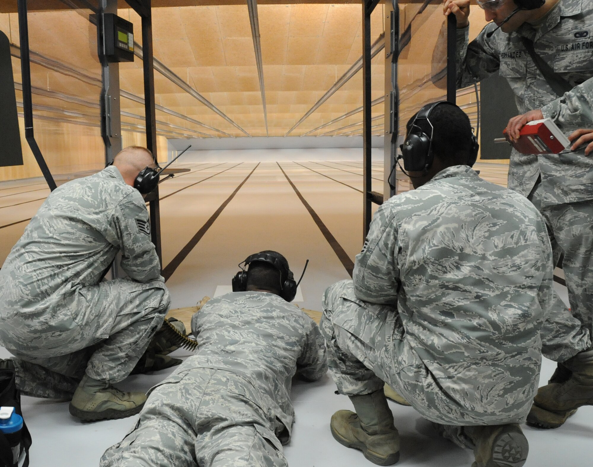 Tech. Sgt. Barry Hardy, 81st Security Forces Squadron combat arms fires an M240B from the prone position into the metal backstop as other 81st SFS members Staff Sgt. Michael O’Neil and Staff Sgt. Richard Gibbs stand by during an indoor firing range safety test March 28, 2012, at Keesler Air Force Base, Miss.  The ricochet containment test was conducted to ensure the metal backstop would catch each round fired.  (U.S. Air Force photo by Kemberly Groue)