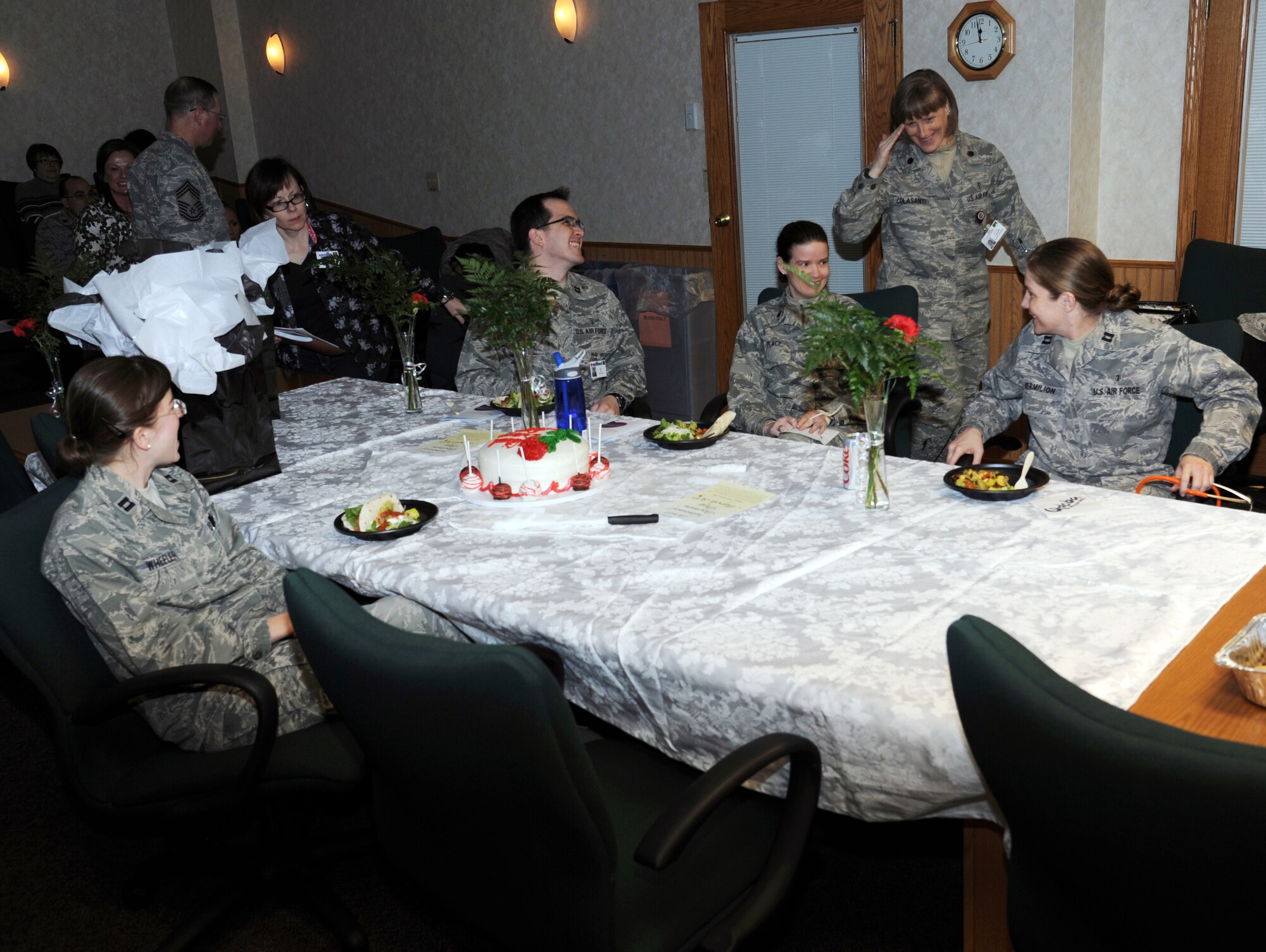 Lt. Col. Marie Colasanti, commander of the 319th Medical Operations Squadron, salutes a table of military doctors to include (from left) Capt. Aubrey Wheeler, Capt. Matthew Hall, Lt. Col. Laura Place and Capt. Kendall Vermillion, during a National Doctor’s Day commemoration ceremony on March 30, 2012, at the 319th Medical Group on Grand Forks Air Force Base, N.D. (U.S. Air Force photo/Tim Flack)