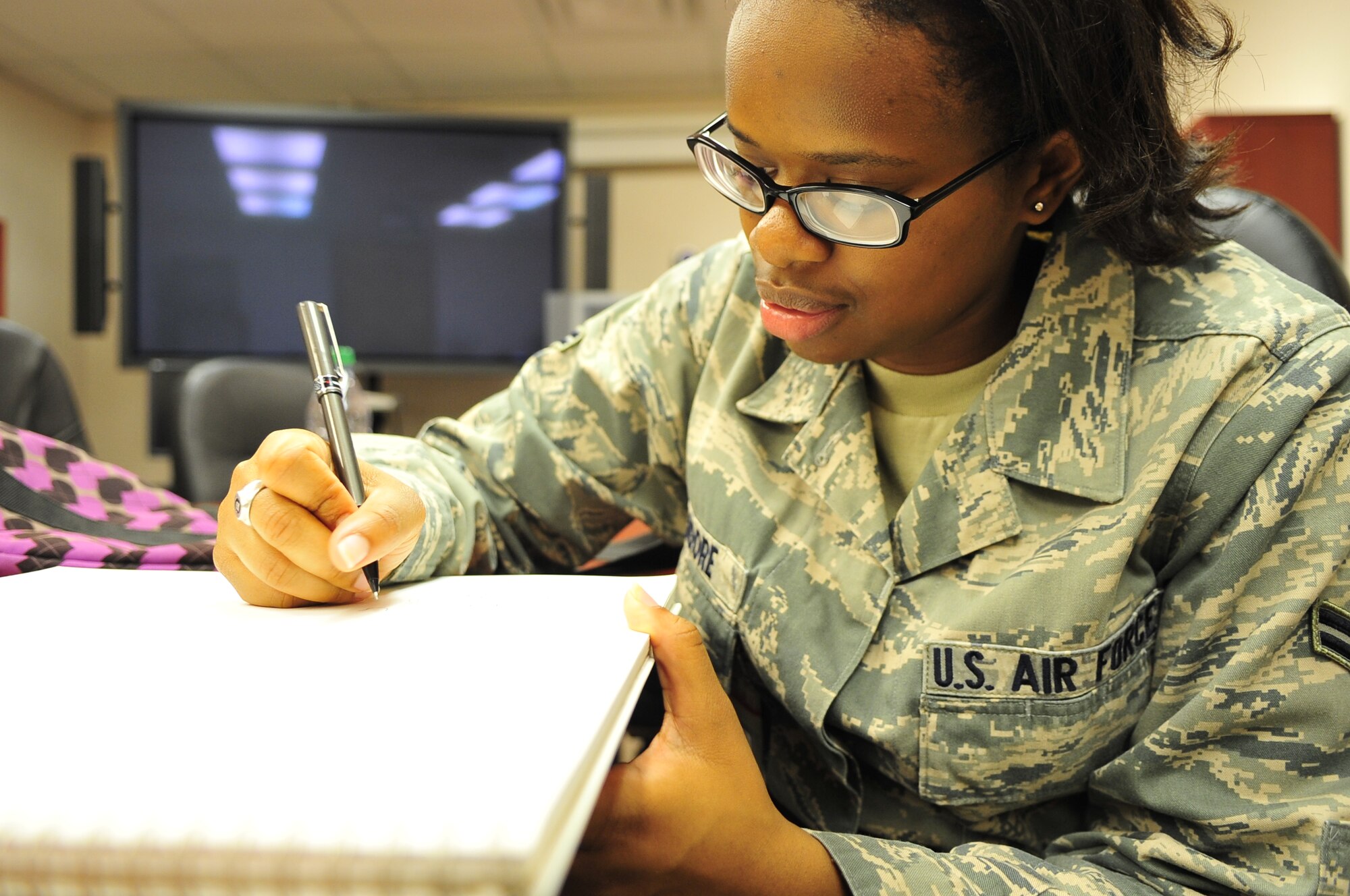 Airman 1st Class Candice Moore, 20th Medical Operations Squadron mental health technician, begins a sketch, Shaw Air Force Base, S.C., March 30, 2012. Moore recently won a competition to create a logo to symbolize dorm life at Shaw. (U.S. Air Force photo by Senior Airman Daniel Phelps/ Released)