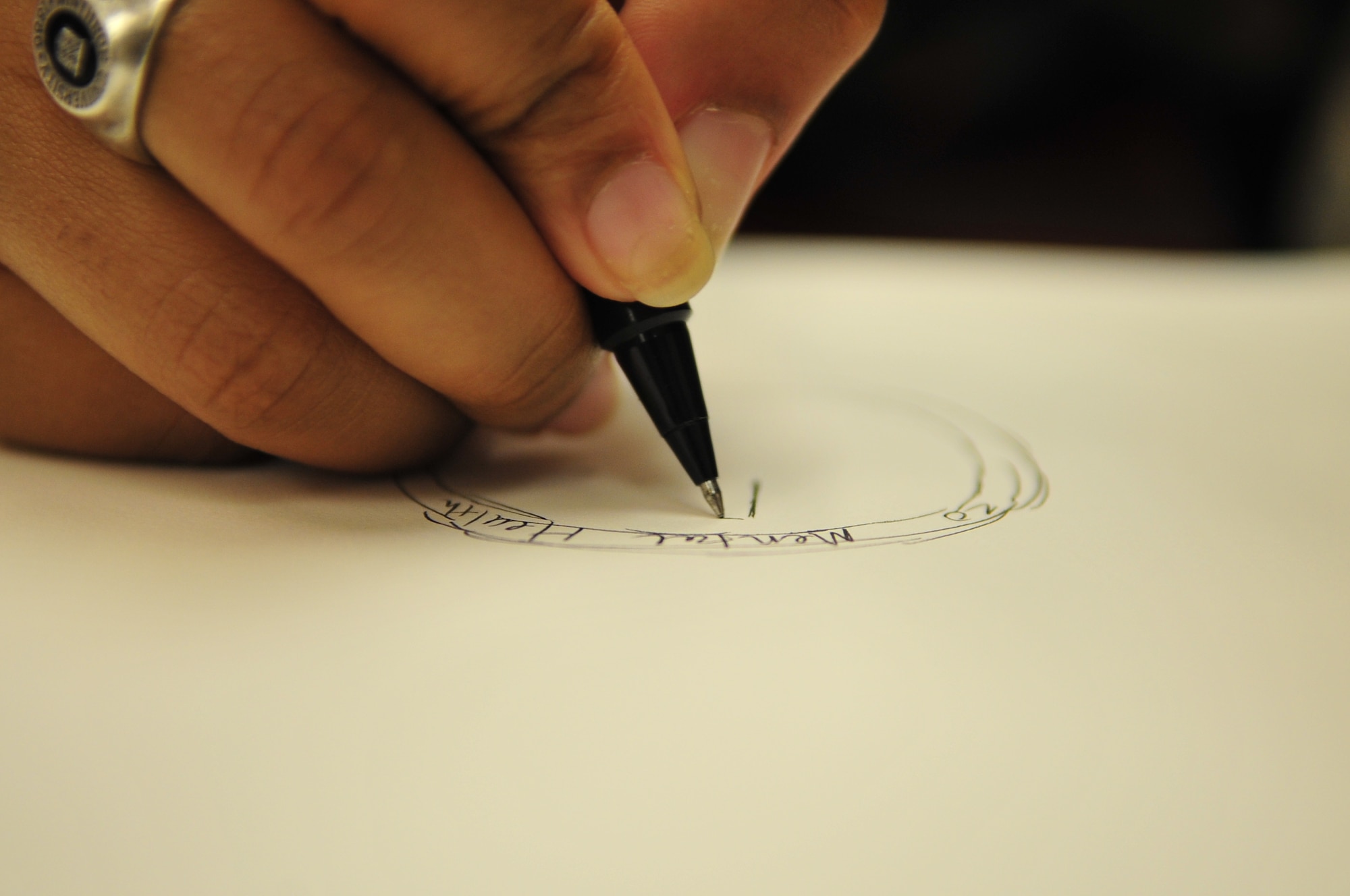Airman 1st Class Candice Moore, 20th Medical Operations Squadron mental health technician, begins a sketch to create a coin for the 20th Medical Group in the mental health conference room, Shaw Air Force Base, S.C., March 30, 2012. She was asked by 20th MDG leadership to design this coin after recently winning a competition to create a logo for Shaw’s dorms. (U.S. Air Force photo by Senior Airman Daniel Phelps)