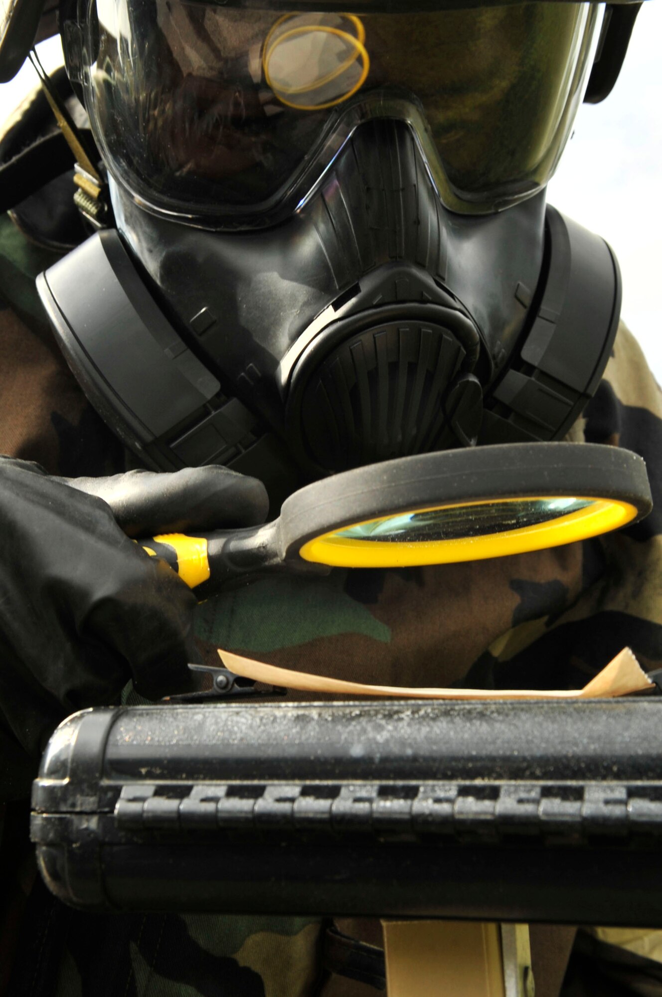 An Airman inspects a piece of M9 paper for contamination during a chemical, biological, radiological, nuclear and explosive training drill, Shaw Air Force Base, S.C., April 3, 2012.  This CBRNE class is one of the few mandatory training courses Airmen must complete before deployment.(U.S. Air Force photo by Airman Nicole Sikorski/Released)