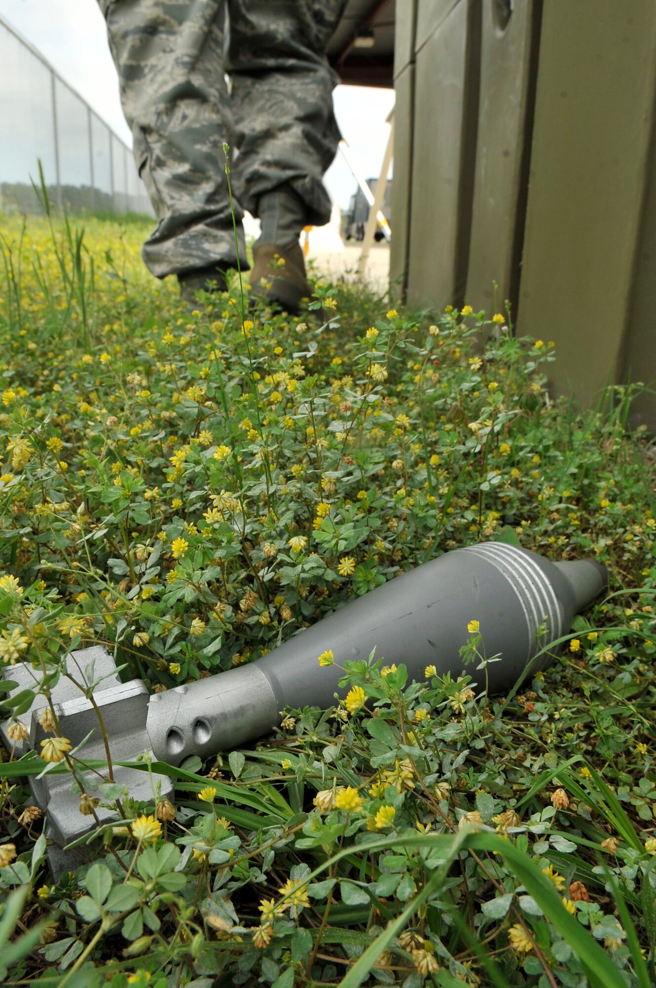 A mock mortar lays hidden in the grass during a chemical, biological, radiological, nuclear and explosive training drill at Shaw Air Force Base, S.C., April 3, 2012.  These Airmen were tasked with finding the explosives during an unexploded ordnance recognition drill.(U.S. Air Force photo by Airman Nicole Sikorski/Released)
