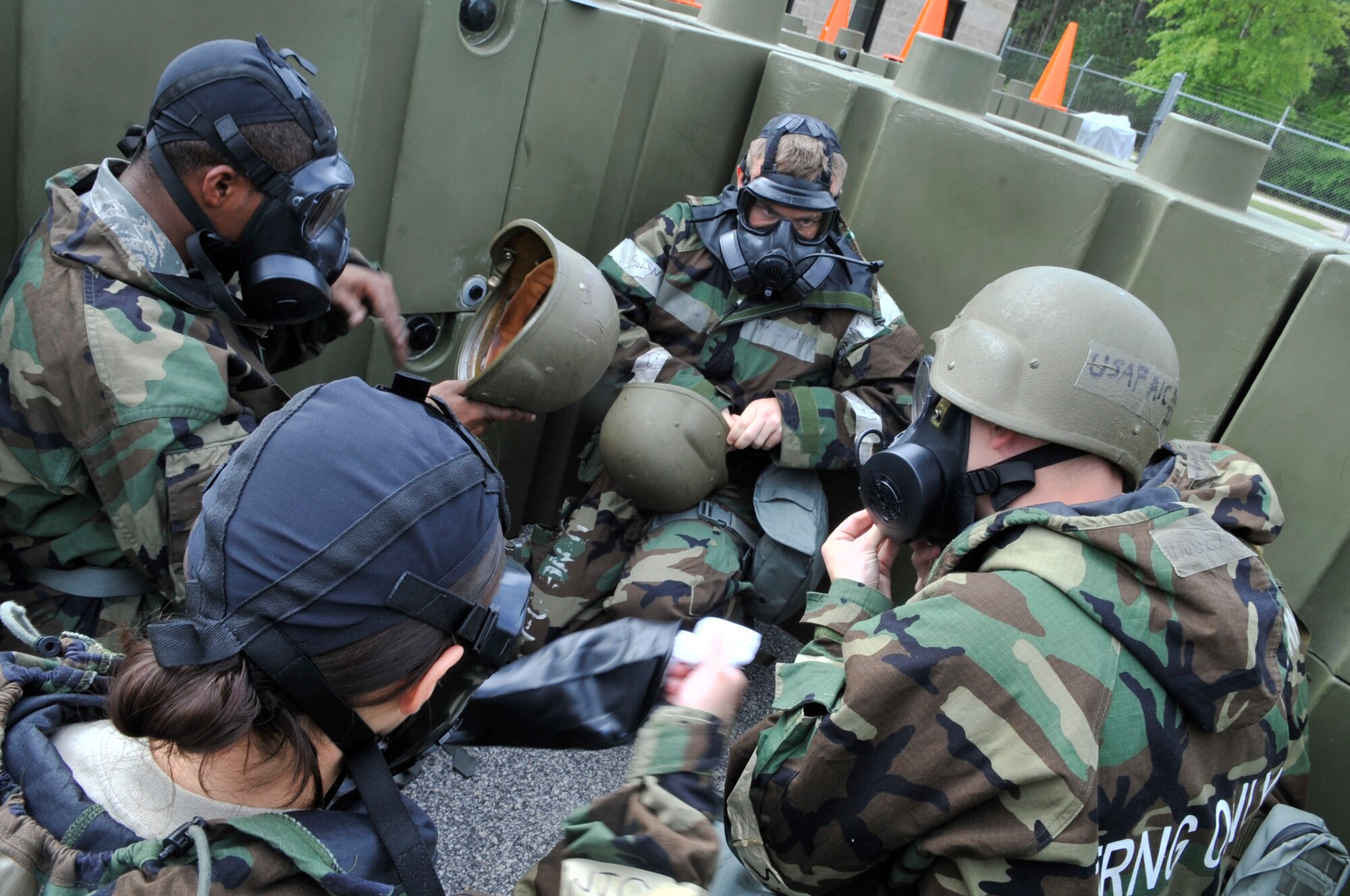 U.S. Air Force Airmen suit up in Mission Oriented Protective Posture gear for a chemical, biological, radiological, nuclear and explosive(CBRNE) training drill at Shaw Air Force Base, S.C., April 3, 2012.  This CBRNE class is one of the few mandatory training courses Airmen must complete before deployment. (U.S. Air Force photo by Airman Nicole Sikorski/Released)