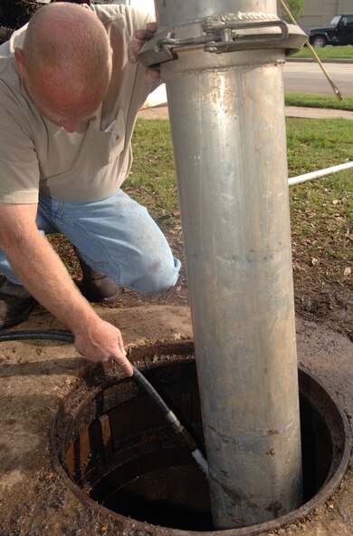 Kevin Mycroft, 2nd Civil Engineer Squadron, cleans out the storm drain system on Barksdale Air Force Base, La., April 4. Mycroft used a combination jetter and vacuum truck to remove build-up of roots and leaves to help keep the streets from flooding. (U.S. Air Force photo/Airman 1st Class Joseph A. Pagán Jr.)(RELEASED)