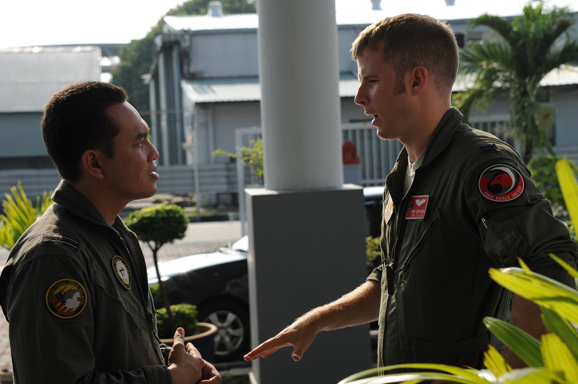 Capt. Phil Johnson (right), 67th Fighter Squadron F-15C pilot, discusses an upcoming sortie with Royal Malaysian Air Force Capt. Mohd Fauzi Abdullah, MiG-29N Fulcrum pilot, following the opening ceremony of Cope Taufan 2012 at TUDM Butterworth Apr. 4, 2012. Cope Taufan, the biennial live-flying exercise between the U.S. Air Force and RMAF, includes dissimilar basic fighter maneuvers and dissimilar air combat tactics training.  (U.S. Air Force photo/Master Sgt. Matt Summers/released)