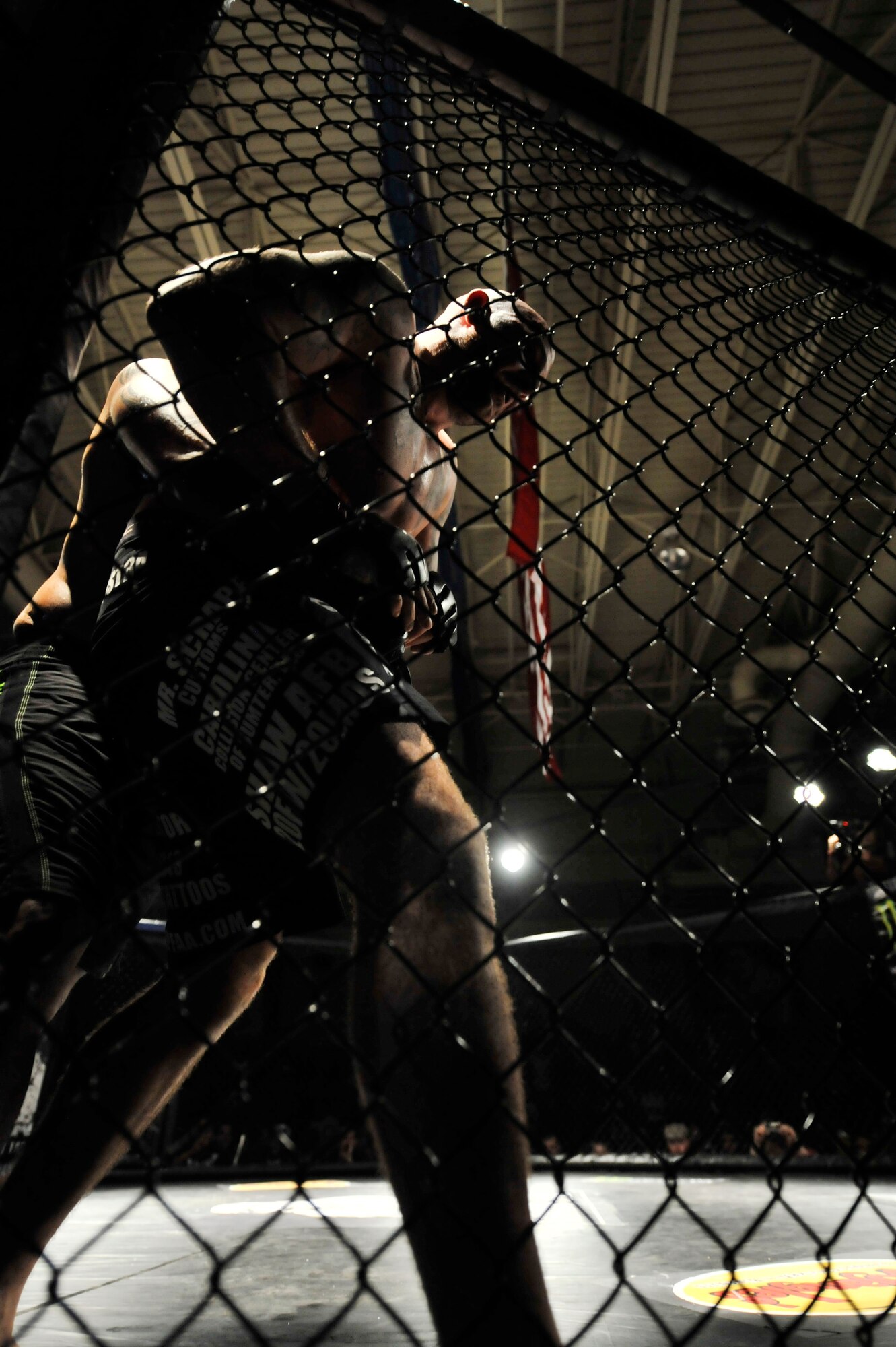 U.S. Air Force Staff. Sgt. Ferdinando Acerra, 20th Maintenance Operations Squadron, maintenance instructor, circles the cage before fighting Josheph Pacheco during Fight Lab’s  Mixed Martial Arts event at the Shaw's Fitness Center, Shaw Air Force Base, S.C., March 30, 2012.  Acerra retained his title in this fight.(U.S. Air Force photo by Airman Nicole Sikorski/Released)
