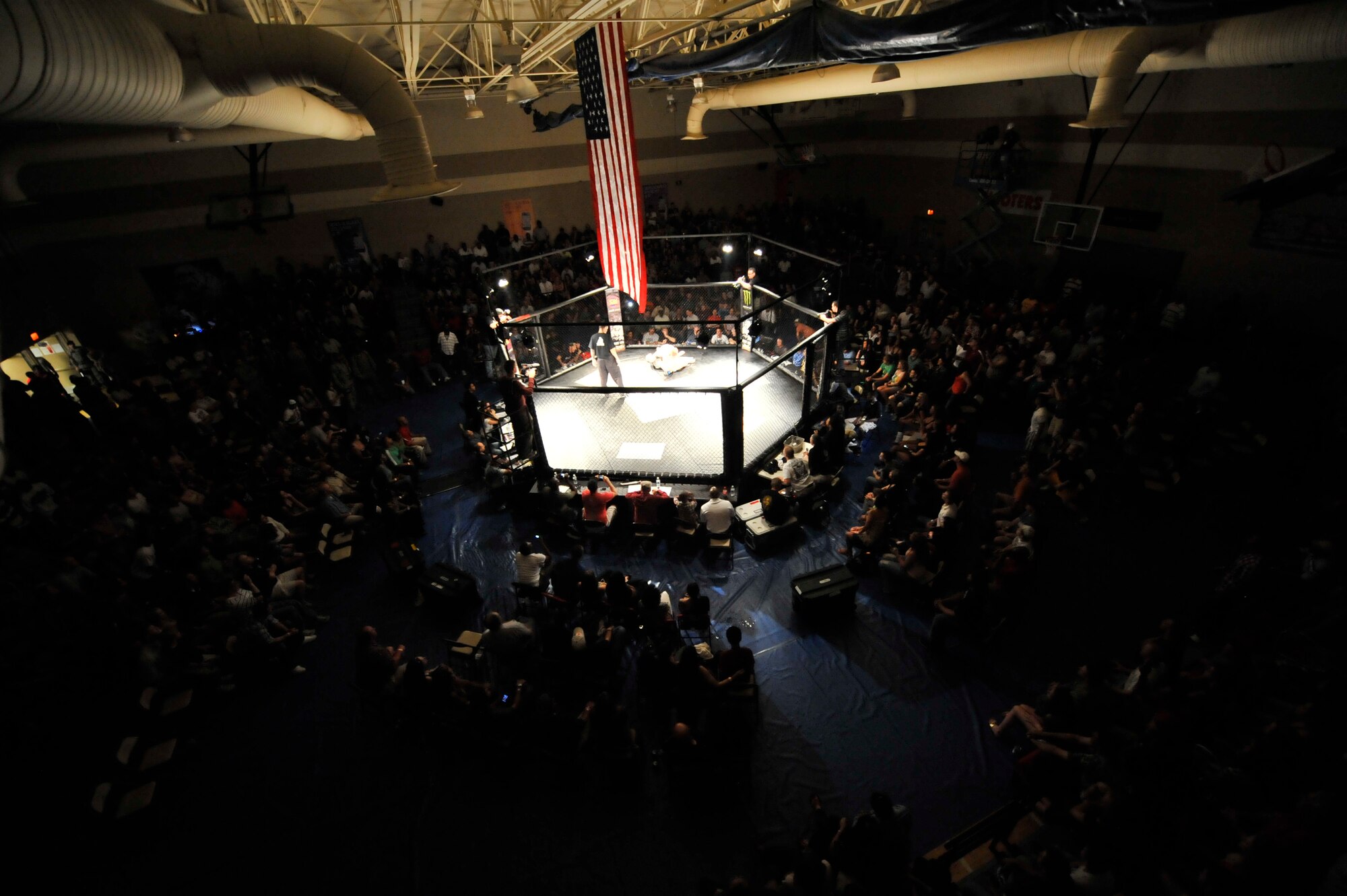 A crowd gathers for Fight Lab's Mixed Martial Arts cage fight at Shaw Air Force Base, S.C., March 30, 2012.  During the main event, Shaw's own, U.S. Air Force Staff. Sgt. Ferdinando Acerra 20th Maintenance Operations Squadron, maintenance instructor retained the title.(U.S. Air Force photo by Airman Nicole Sikorski/Released)
