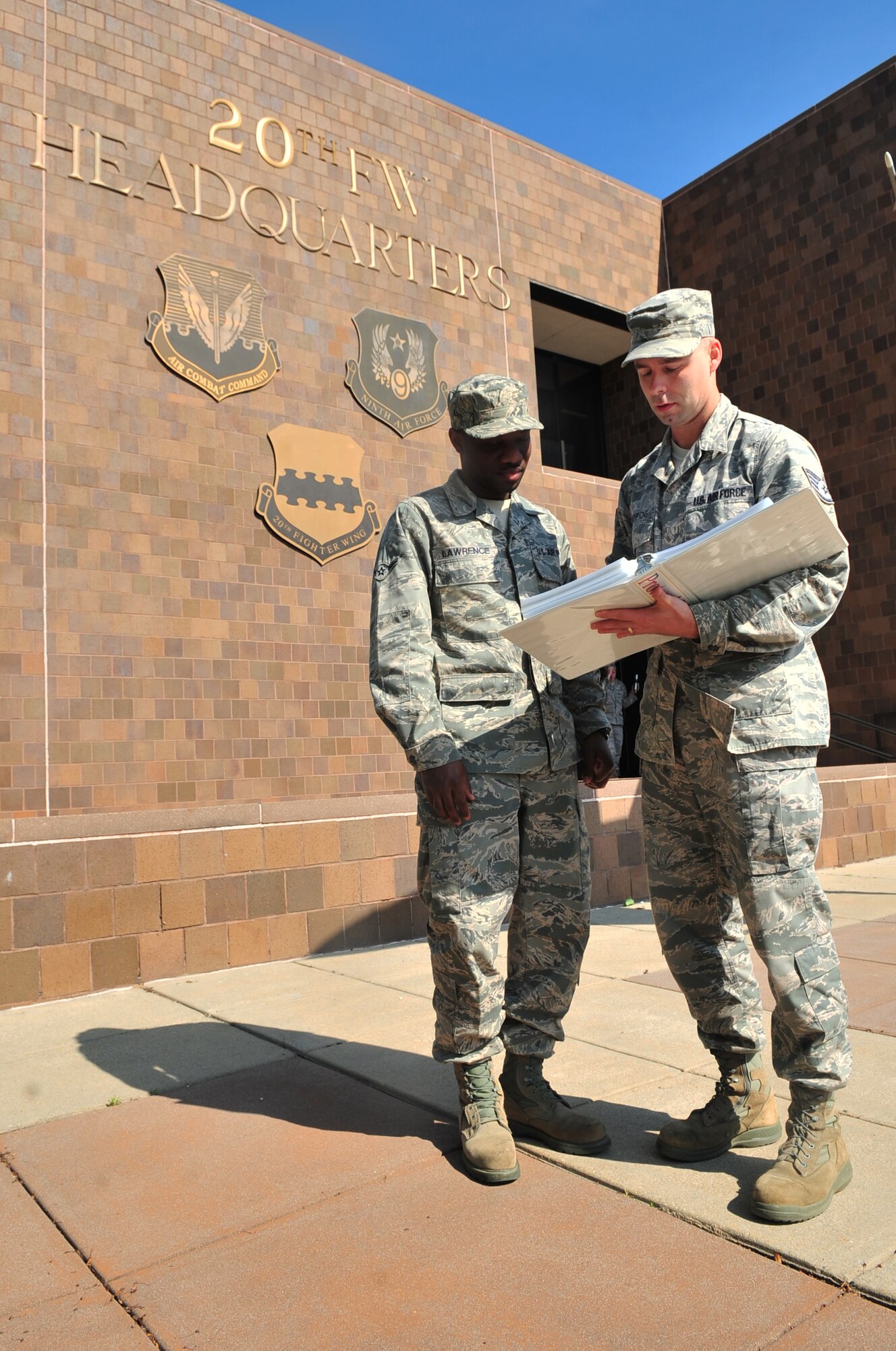 U.S. Air Force Staff Sgt. Charles Kropog, 20th Fighter Wing protocol, goes over protocol procedures with Airman Cliffeton Lawrence 20th FW knowledge operations manager, Shaw Air Force Base, S.C., April 4, 2012. An Airman is nominated for the Shaw Spotlight weekly due to their outstanding progression and effort in their job. (U.S. Air Force photo by Airman 1st Class Ashley L. Gardner/ Released)
