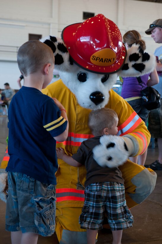 A child hugs Sparky the Fire Dog during the Month of the Military Child block party at Ellsworth Air Force Base, S.D., March 31, 2012. Month of the Military Child is a time set aside to recognize military children for the sacrifices and challenges they face. (U.S. Air Force photo by Airman 1st Class Zachary Hada/Released)