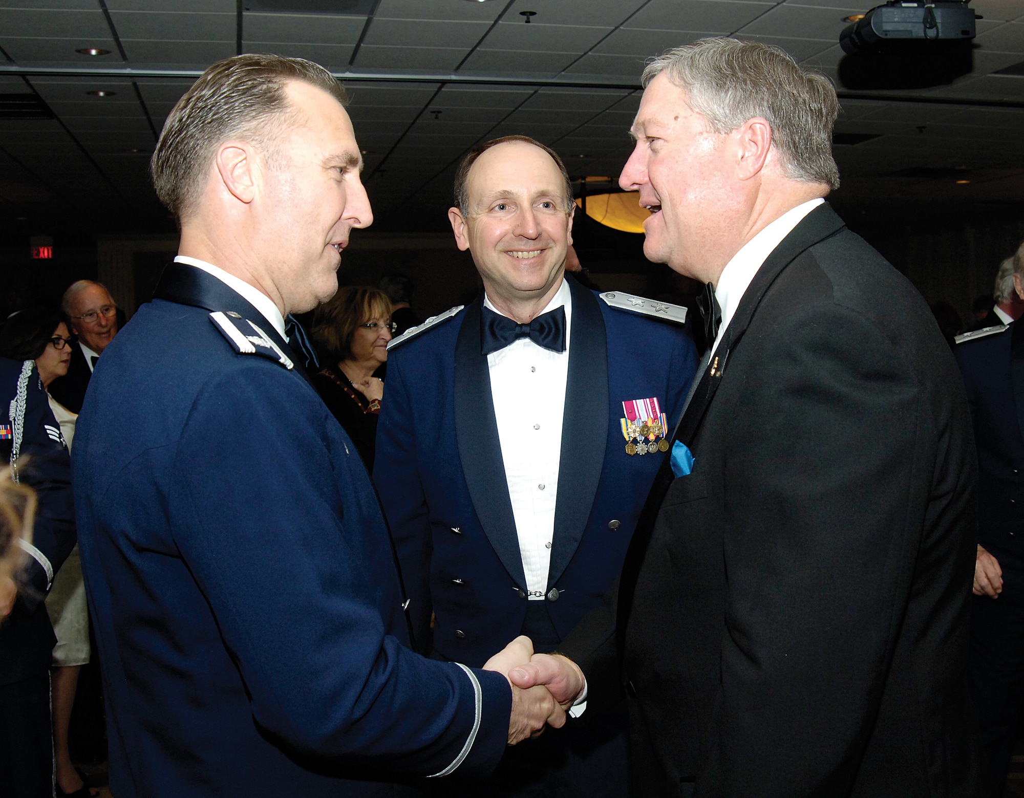 Secretary of the Air Force Michael Donley, right, greets Lt. Col. Rick Johns during the 39th Tinker and Community Dining Out held March 30, on base for a capacity crowd at the Tinker Club. Maj. Gen. Bruce Litchfield, Oklahoma City Air Logistics Center commander, hosted the secretary, who was the featured speaker during the annual event that celebrates the relationship between the base and surrounding community. Colonel Johns, the 72nd Air Base Wing’s Mission Support Group deputy commander, served as “Mr. Vice” during the Dining Out. (Air Force photo by Margo Wright)