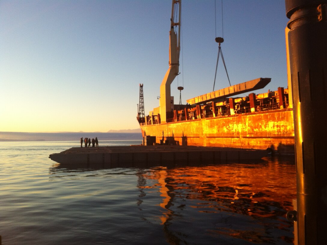 The crane aboard the USNS Green Wave hoists pieces of a modular causeway system at McMurdo Station, Antarctica, February 2012. The Army’s 331st Transportation Company built a pier to unload supplies for the National Science Foundation base. (U.S. Army photo/Capt. Christina Shelton)  
