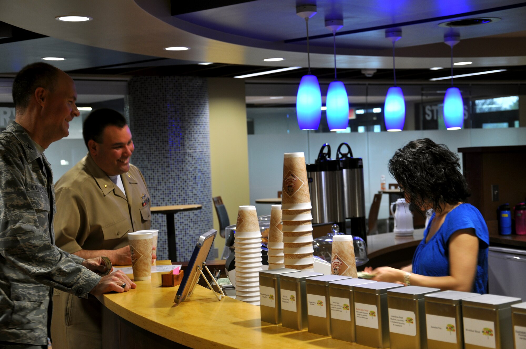 Col. John Knowles, Air Mobility Command weather director, and Lt. Cmdr. Casey Roskelly, commercial passenger planner, await their highly anticipated morning coffee at St. Louis Coffee Roasters within the Global Reach Grill located at Air
Mobility Command Headquarters, Scott Air Force Base, Ill., March 21, 2012.
St. Louis Coffee Roasters provides more than 16 gallons of coffee, tea and
other beverages to Scott customers each day. (U.S. Air Force photo/Theo Ramsey)