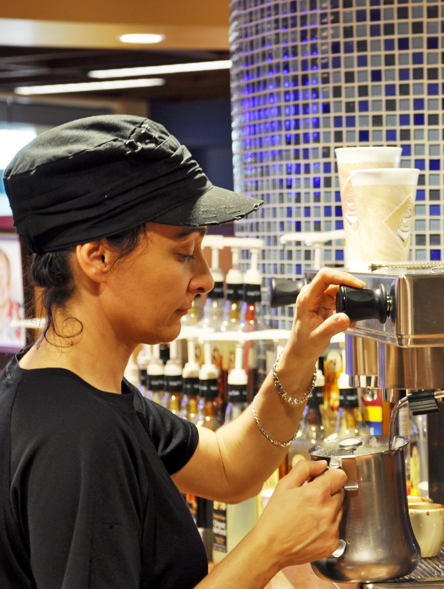 Asli Stewart, native of Turkey and a 5-year barista at St. Louis Coffee Roasters, steams milk for a customer March 20, 2012, at Scott Air Force Base, Ill. St. Louis Coffee Roasters is located at the Global Reach Grill on the first floor of Air Mobility Command Headquarters.(U.S. Air Force photo/Theo Ramsey)