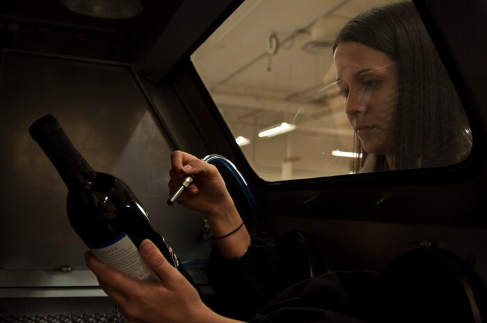 Myrna Loughery, 99th Force Support Squadron Arts and Crafts Center laser engraver, uses the glass engraver to etch a phrase into a decorative bottle March 30, 2012 at Nellis Air Force Base’s Arts and Crafts Center. The Arts and Crafts Center provides a learning environment with opportunities for Airmen to save money. (U.S. Air Force photo by Senior Airman Jack Sanders)