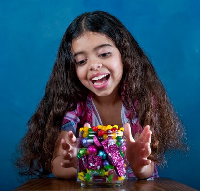 Angelina Bainter poses with a bowl full of candy at Hurlburt Field, Fla., April 3, 2012. Parents should monitor their children’s candy intake during the Easter holiday as well as throughout the year. (U.S. Air Force photo/Senior Airman John Bainter)(Released) 
