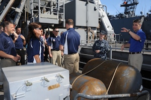 U.S. Navy Petty Officer 1st Class Cynthia Cruz, U.S.S. Oak Hill culinary specialist, gives the 2012 Air Combat Command Outstanding Airmen of the Year nominees a tour of the cargo ship at Joint Expeditionary Base Little Creek – Fort Story, Va., April 3, 2012. Nominees and their guests attended the 3-day professional development seminar as part of the 2012 ACC OAY Conference at Langley Air Force Base, Va. (U.S. Air Force photo by Airman 1st Class Teresa Cleveland/Released)