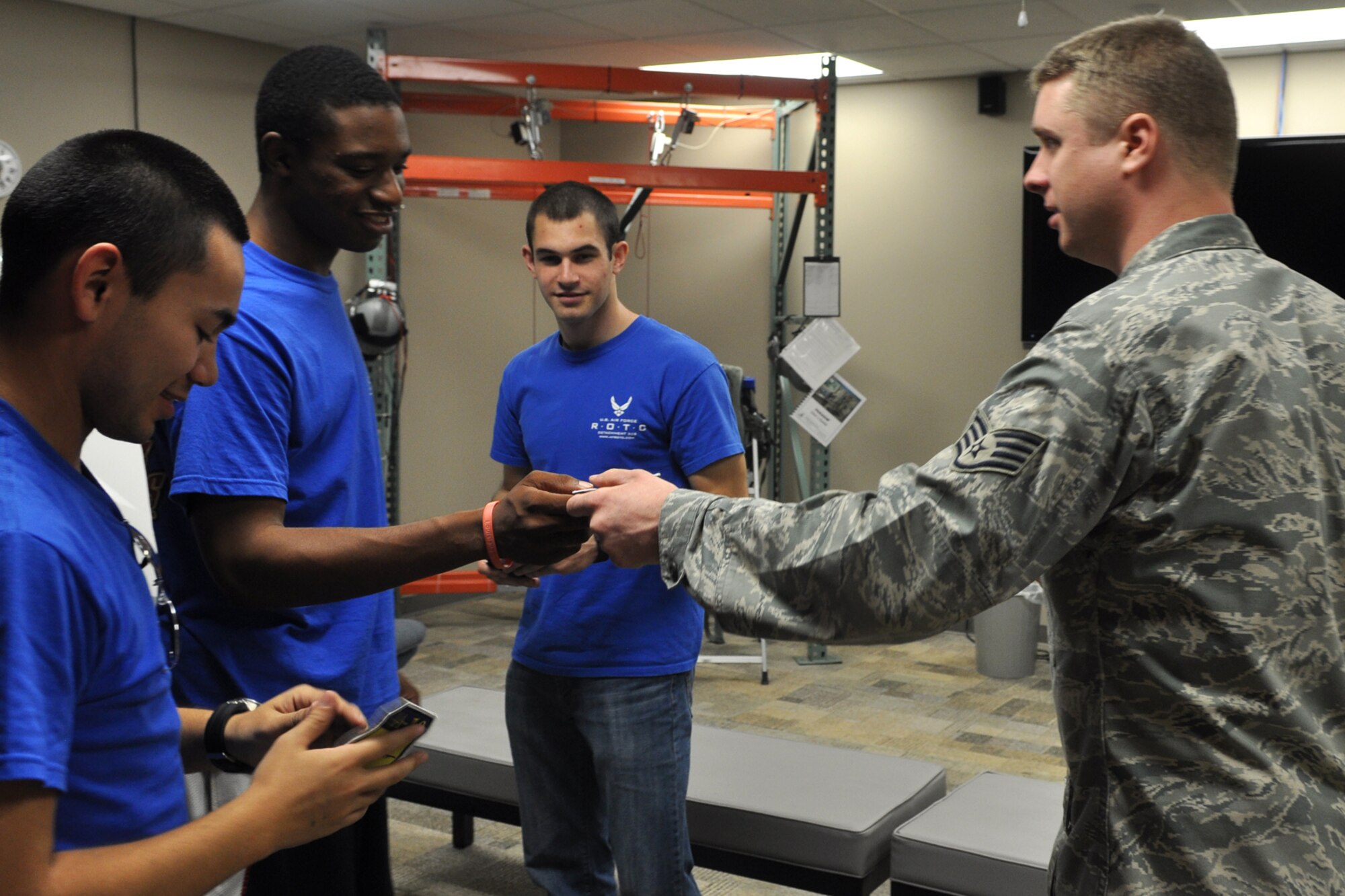 Staff Sgt. Raymond Gregory, an aircrew flight equipment specialist assigned to the 47th Fighter Squadron, passes out A-10 patches to cadets from the AFROTC Detachment, 305th Airpower Group, Louisiana Tech University, March 31, 2012, at Barksdale Air Force Base, La. The cadets were part of a group who visited Barksdale to get a look at one of their possible futures. (U.S. Air Force photo by Master Sgt. Jeff Walston/Released) 