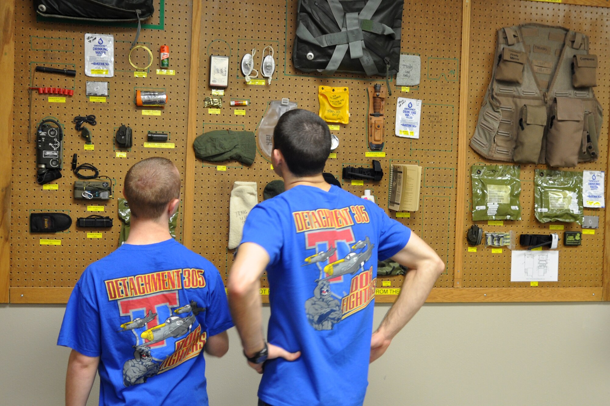 Cadet 3rd Class Joshua Ayrton and Cadet 4th Class Brayden Decker take a close-up look at some of the survival equipment supplied to an A-10 Thunderbolt II pilot, during their visit to the life support shop at the 47th Fighter Squadron building on Barksdale Air Force Base, La., March 31, 2012. The two cadets were part of a group from the AFROTC Detachment, 305th Airpower Group, Louisiana Tech University, who visited Barksdale to get a look at one of their possible futures. (U.S. Air Force photo by Master Sgt. Jeff Walston/Released) 