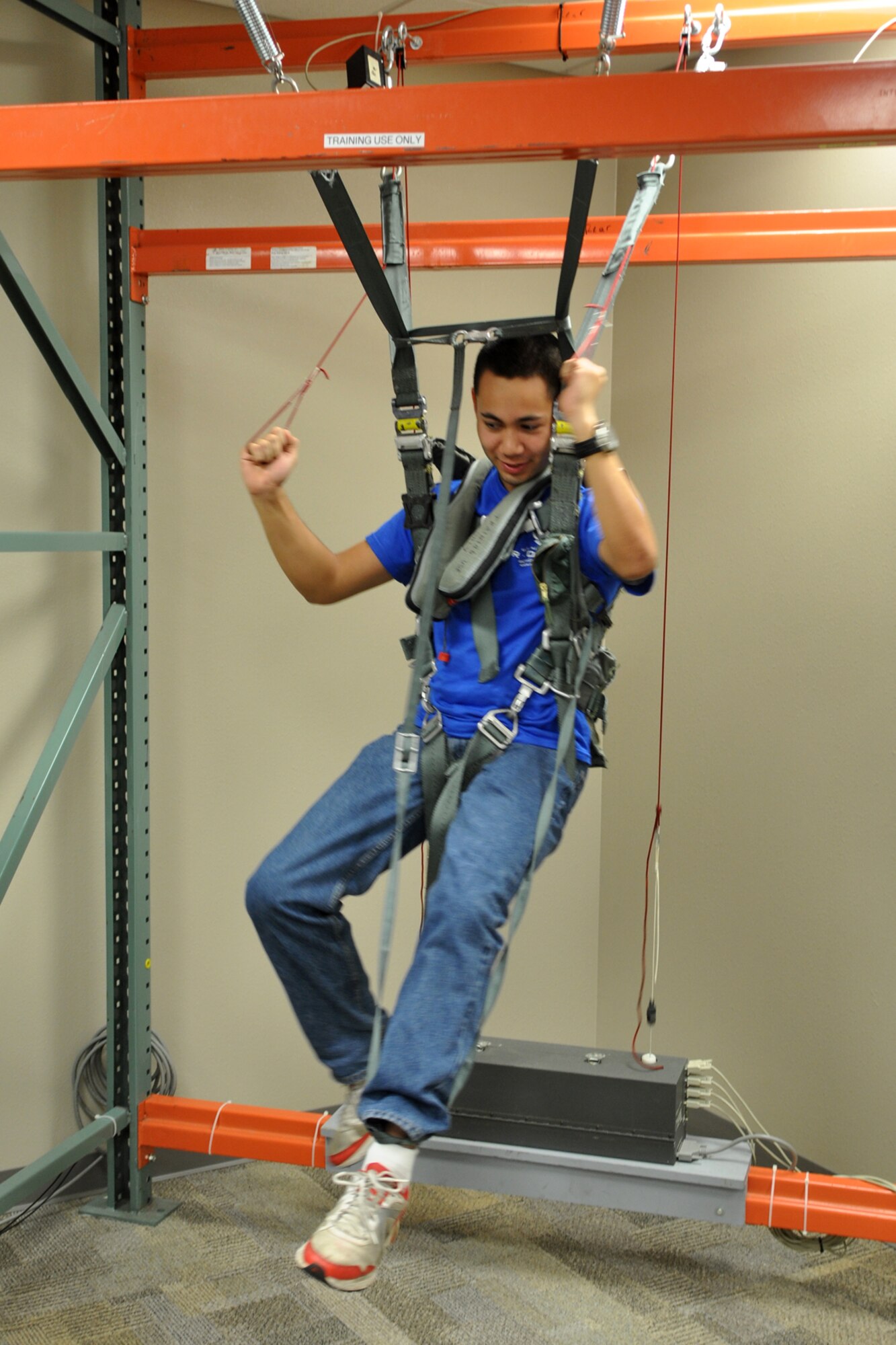 Cadet 4th Class Joshua Davis hangs from a parachute harness in the life support shop at the 47th Fighter Squadron building during a visit to Barksdale Air Force Base, La., March 31, 2012. A group of cadets from the AFROTC Detachment, 305th Airpower Group, Louisiana Tech University, received several different briefings about the capabilities of the A-10 Thunderbolt II during their visit to Barksdale. (U.S. Air Force photo by Master Sgt. Jeff Walston/Released)