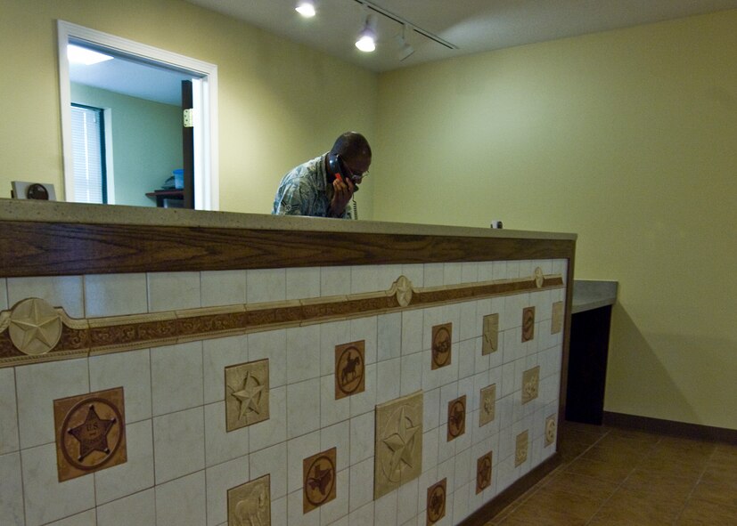 Airman 1st Class Williams Waitman, 7th Force Support Squadron, helps a guest make a reservation at the newly renovated Dyess Inn front desk March 29, 2012, Dyess Air Force Base, Texas. Inns of Dyess recently completed the last of its renovations projects. Enhancements to the building include a new paint job, carpet, vanities, counter tops, TVs, DVD players, mattress sets, sofas, lounge chairs and desk chairs. The renovation began in December 2010 and ended on Feb. 8, 2012. The two-year project upgraded the interior of building 6240, 7407 and 7409. Building 7409 will officially re-open April 9, with a ribbon-cutting ceremony. (U.S. Air Force photo by Airman 1st Class Damon Kasberg/Released)