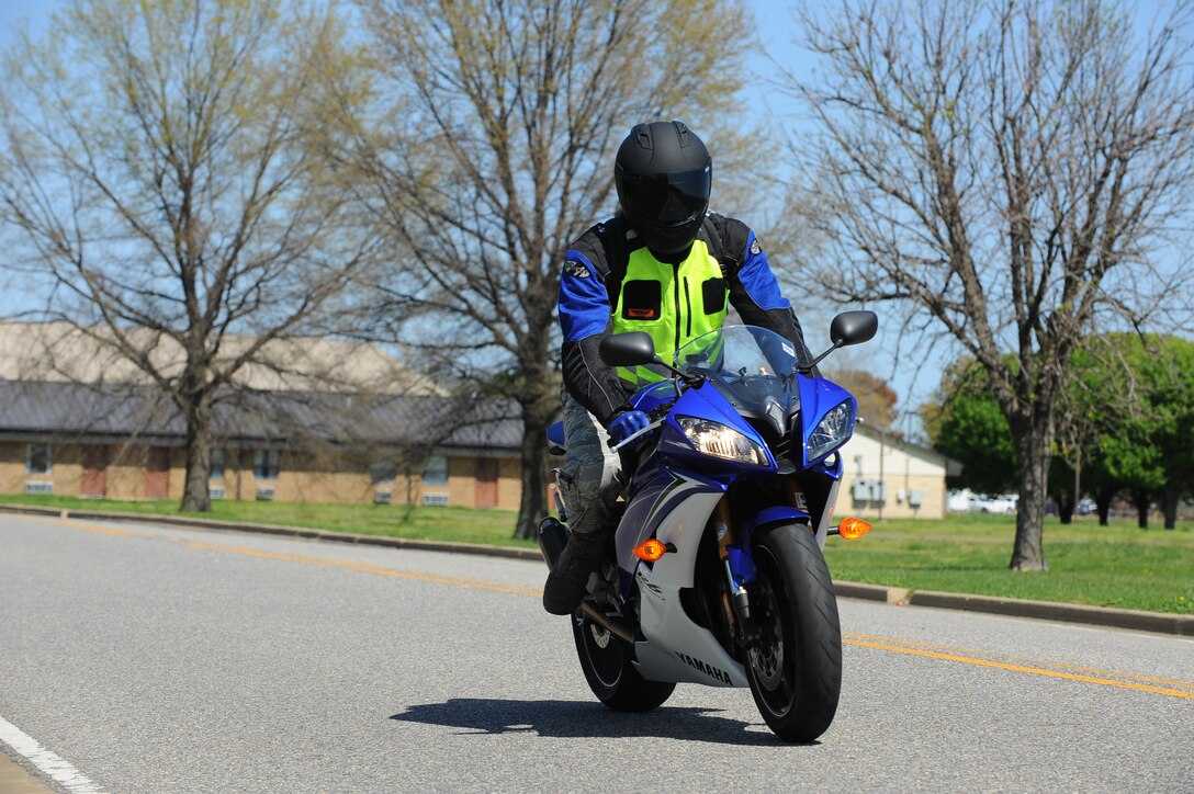 A motorcycle rider, clad in appropriate personal protective gear, drives along Ward Road during the 30th Intelligence Squadron’s motorcycle safety rally at Langley Air Force Base, Va., March 26, 2012. The purpose of the rally was to educate riders about safe riding practices and important regulations to follow during the upcoming motorcycle season. (U.S. Air Force photo by Airman 1st Class Austin Harvill/Released)