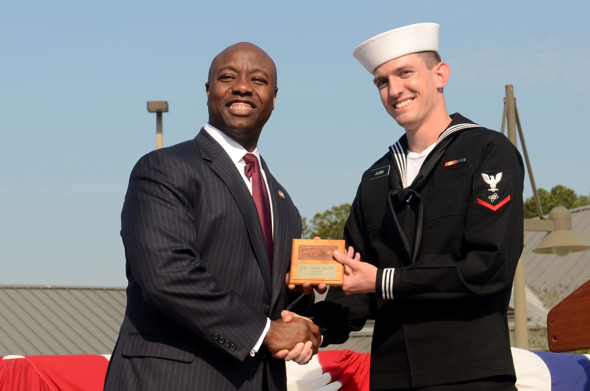 Petty Officer 3rd Class James Jacobs receives the class Honorman award from Rep. Tim Scott during the Naval Nuclear Power Training Command graduation ceremony for class 1107 at Joint Base Charleston – Weapons Station, March 30. The Class Honorman is the Sailor with the highest grade point average for the enlisted class. Scott is the South Carolina first district congressman.  (U.S. Air Force photo/Tech Sgt. Chrissy Best)