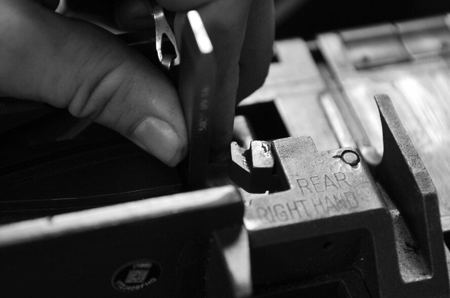 Staff Sgt. Katrina Aide, 51st Security Forces Squadron combat arms instructor, checks head space on a M2 Browning Machine Gun at Osan Air Base, Republic of Korea, April 4, 2012. (U.S. Air Force photo/Staff Sgt. Craig Cisek) 
