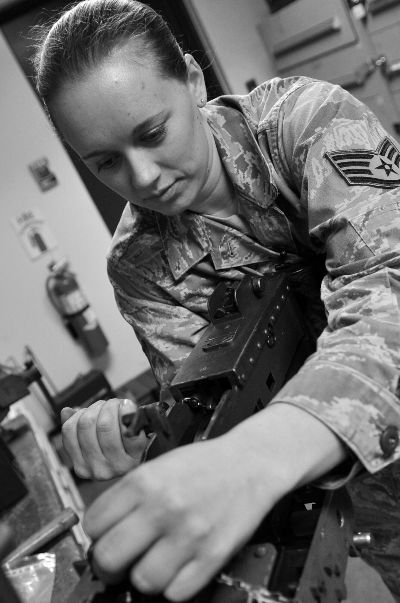 Staff Sgt. Katrina Aide, 51st Security Forces Squadron combat arms instructor, engages the charging handle prior to checking the head space of a M2 Browning Machine Gun here, Apr. 4, 2012. Checking the head space is a procedure prior to a function check to ensure correct spacing between the barrel and bolt. (U.S. Air Force photo/Staff Sgt. Craig Cisek)