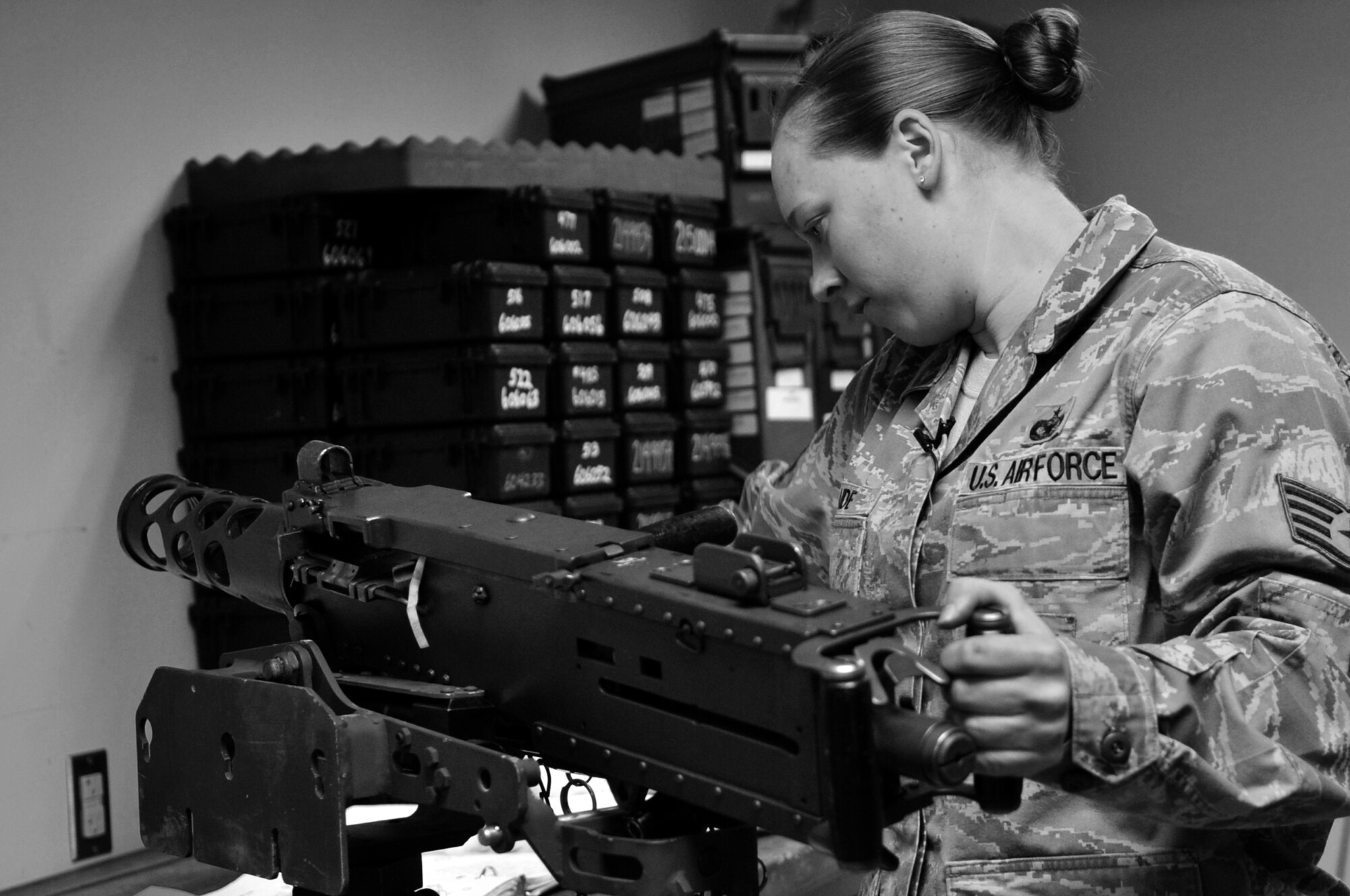 Staff Sgt. Katrina Aide, 51st Security Forces Squadron combat arms instructor, places a M2 Browning Machine Gun into a cradle prior to performing an inspection of the small arms weapon system here, Apr. 4, 2012. (U.S. Air Force photo/Staff Sgt. Craig Cisek)