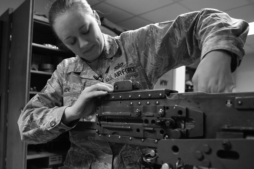 Staff Sgt. Katrina Aide, 51st Security Force Squadron combat arms instructor, removes the bolt from a M2 Browning Machine Gun here, Apr. 4, 2012. Aide performs checks to ensure the operational capability of the heavy machine gun. (U.S. Air Force photo/Staff Sgt. Craig Cisek)