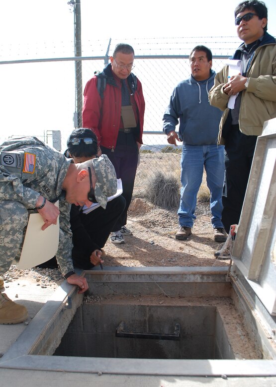 SANTA CLARA PUEBLO, N.M., -- FEST members talk to Santa Clara Pueblo member Adrian Garcia (in blue) about the
Pueblo’s water system.