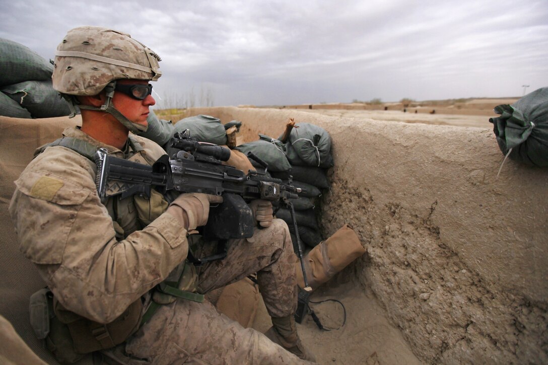 U.S. Marine Corps Cpl. Daniel Thompson posts security while members of an Afghan narcotics interdiction unit search a compound during Operation Speargun in Urmuz, Afghanistan, March 27, 2012. Thompson is a fire team leader assigned to Alpha Company, 1st Combat Engineer Battalion, 8th Marine Regiment.