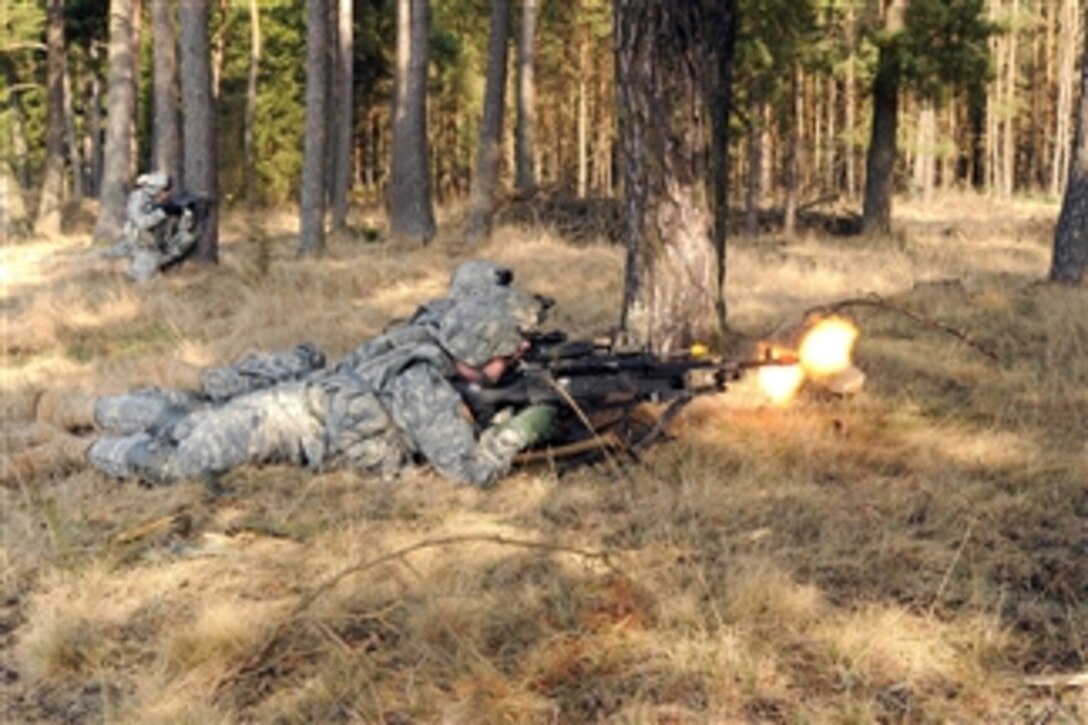 U.S. Army soldiers take cover firing their weapons during a situational training exercise at Grafenwoehr Training Area, Joint Multinational Training Command in Vilseck, Germany, on March 22, 2012.  