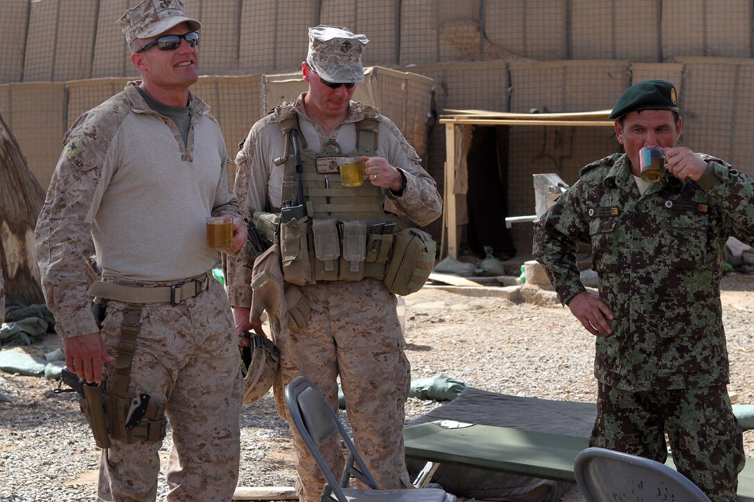 (From left) U.S. Marine Col. Roger Turner, the Regimental Combat Team 5 commanding officer, Lt. Col. Baron Harrison, RCT-5 Brigade Advisor Team officer in charge, and Afghan National Army Col. Mohammad Sarwar Kushal, the 1st Brigade, 215th Corps executive officer, share a cup of tea here, April 4, 2012. Turner and members of his staff visited Marines aboard Patrol Base Beirut during a recent trip to several combat outposts in Helmand province’s Marjah district.