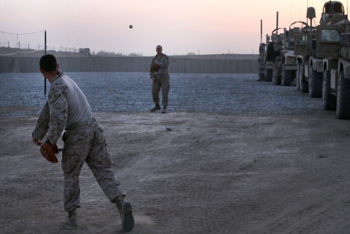 U.S. Marine Lance Cpl. Jake Black, a native of Ohio, and Navy Petty Officer Ryan Hall, a native of Ocala, Fla., play catch during an overnight stop here April 4, 2012, while touring the 2nd Battalion, 9th Marine Regiment area of operations. The ballplayers are part of their battalion’s provisional security detail, who also share responsibilities with the battalion’s quick reaction force.