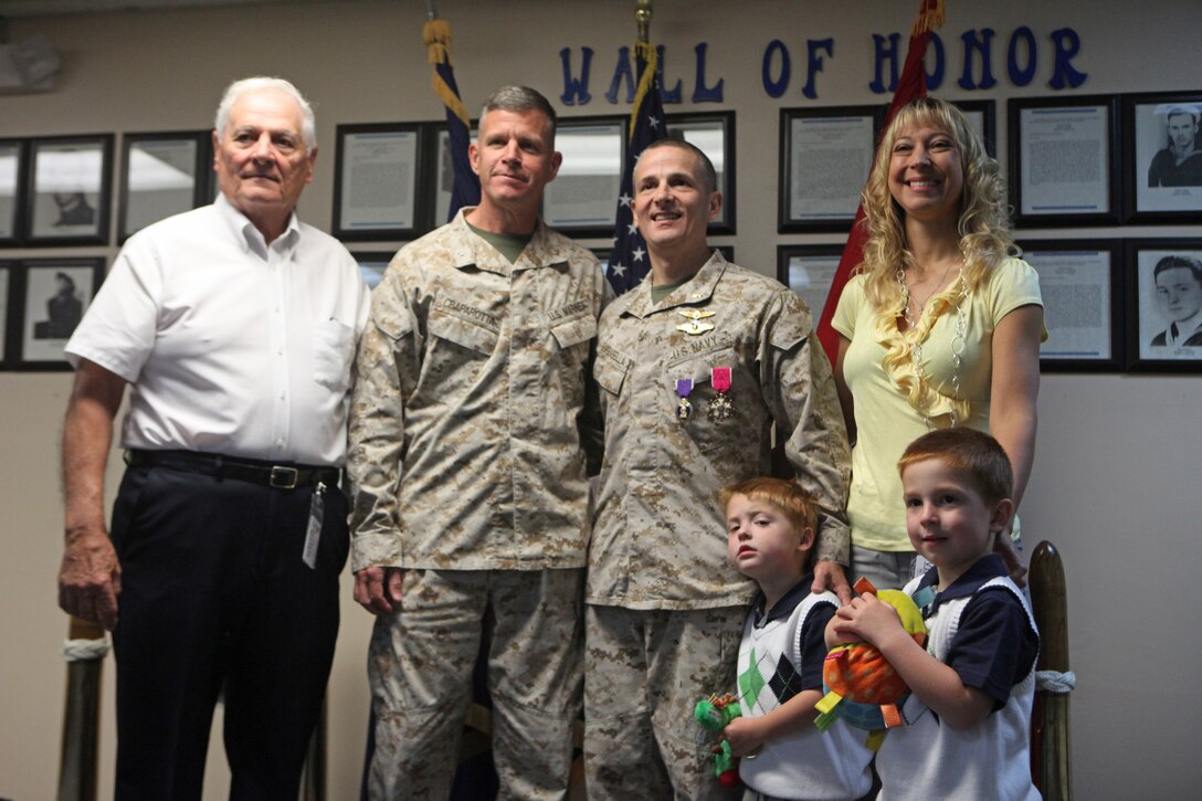 (Left to right) New Salem, Pa., native Vincent M. Barbabella Sr.; Brig. Gen. Lewis A. Craparotta; Birdsboro, Pa., native Cmdr. Sean Barbabella,  and Cmdr. Barbabella’s wife and children take time for a photo after the commander’s awards ceremony April 5.  Craparotta awarded Barbabella the Legion of Merit, one of the military’s highest awards for his service as the 2nd Marine Division (Forward) division surgeon.  “It’s a privilege for me as a medical doctor out there to take care of guys who sacrifice so much,” said Barbabella.  “There is a lot of supporting cast out there – among them, my wife, whose unwavering support allows me to do my job.  It was an honor to be a part of that team and take care of these guys.”  Craparotta served as the 2nd MarDiv (Fwd) commanding general and presented the award during the ceremony.